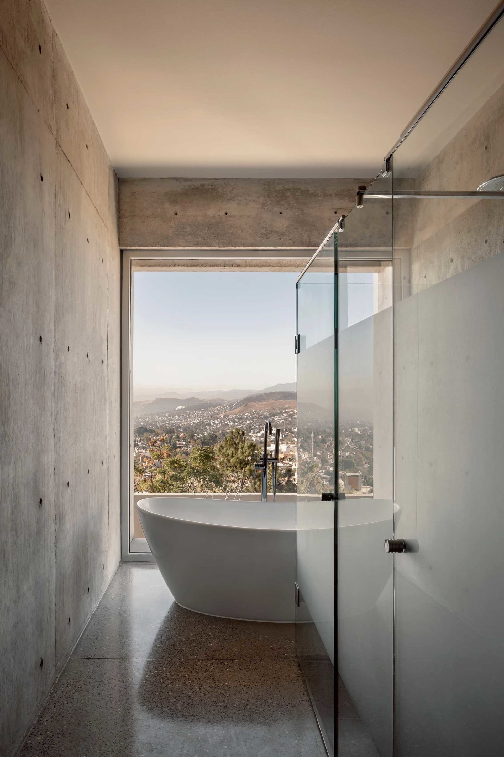 Modern residential bathroom with spa features and concrete walls.