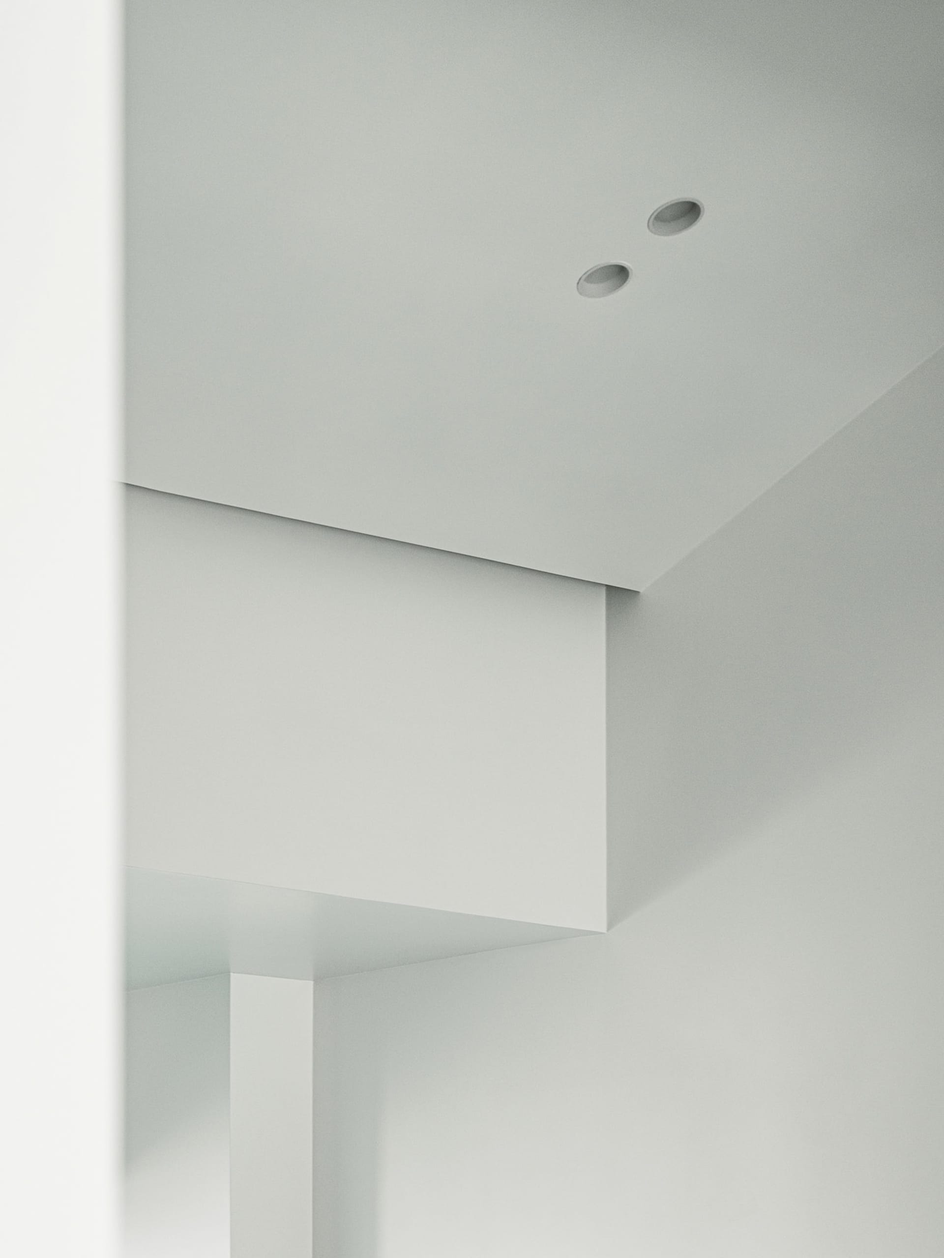 A minimalist interior design with white walls and a clean, uncluttered space.