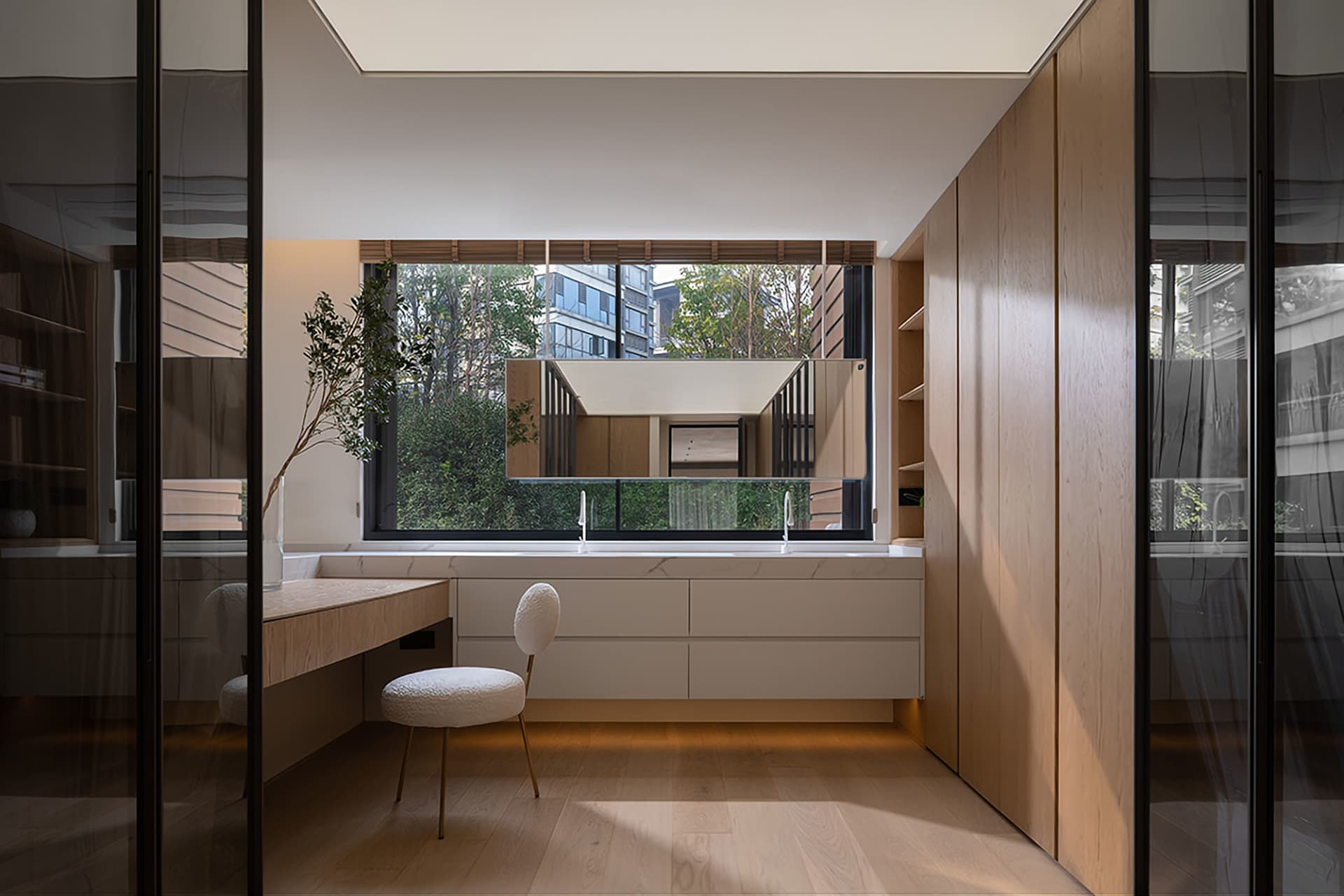 Modern minimalist bathroom vanity with a window, featuring clean lines and a sleek design.