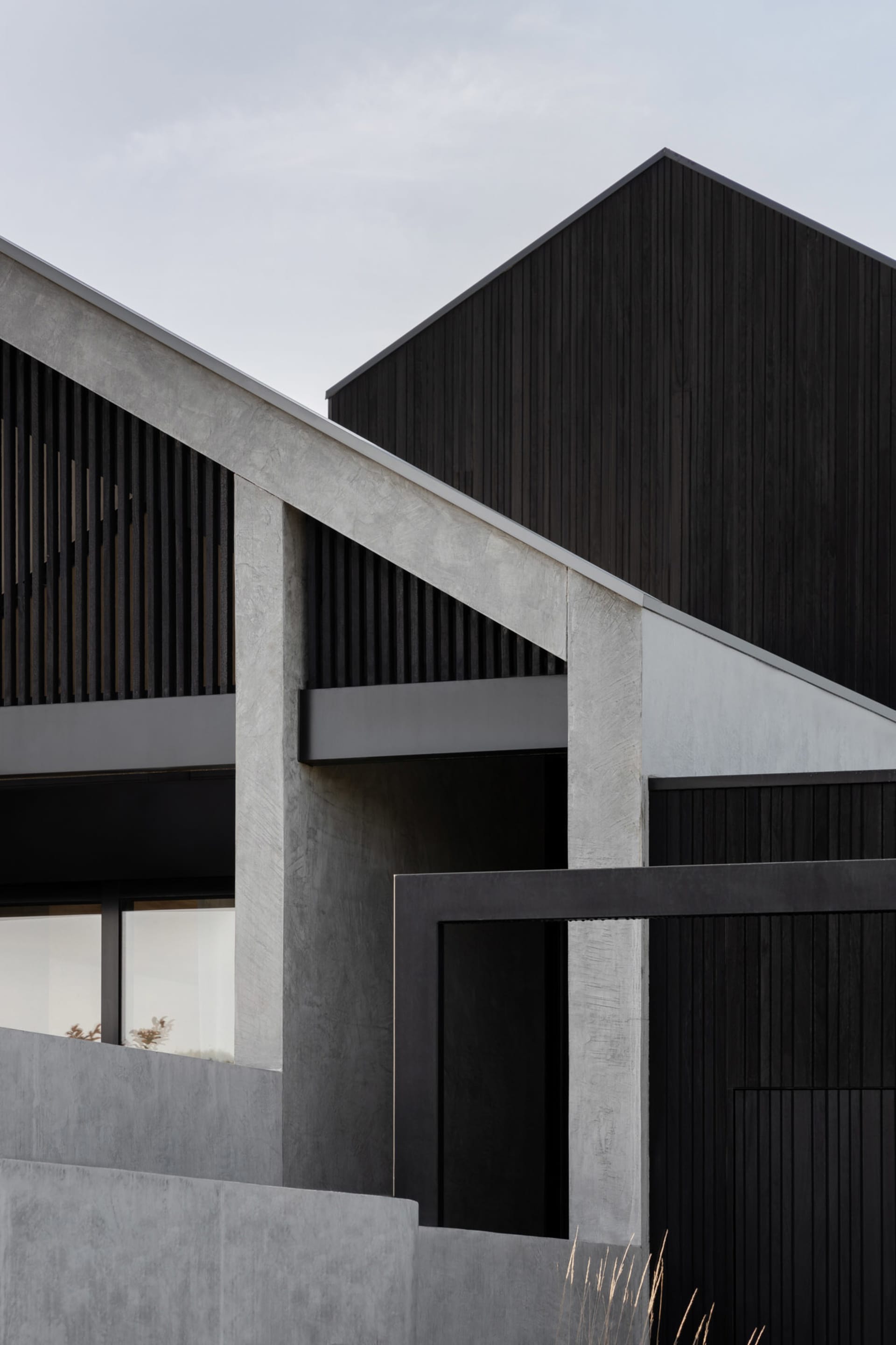 Modern residential exterior featuring concrete and wood materials
