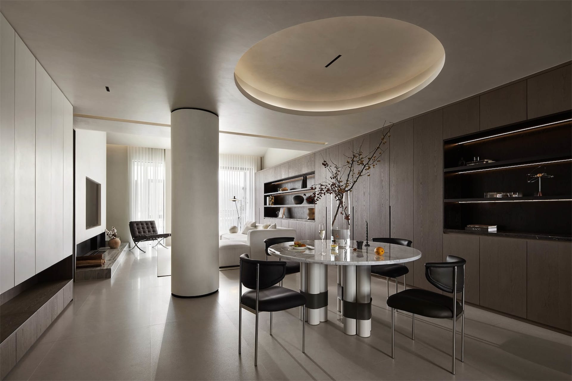 Modern dining room featuring a marble dining table, metal chairs, and wooden accents.