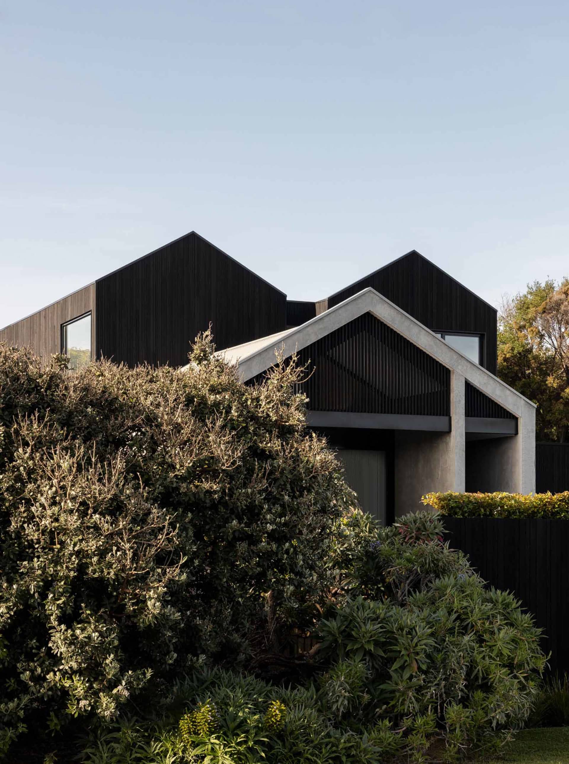 A modern house featuring a combination of concrete and wood materials.
