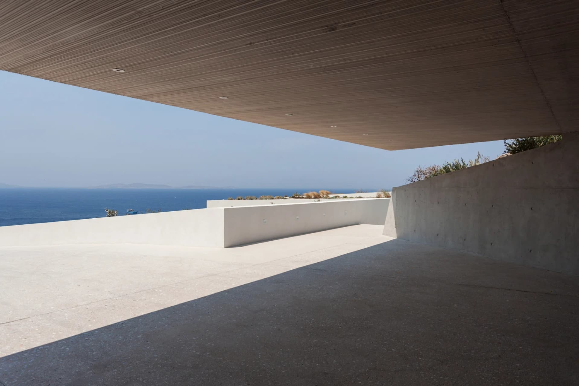 Modern vacation home with concrete terrace overlooking the sea