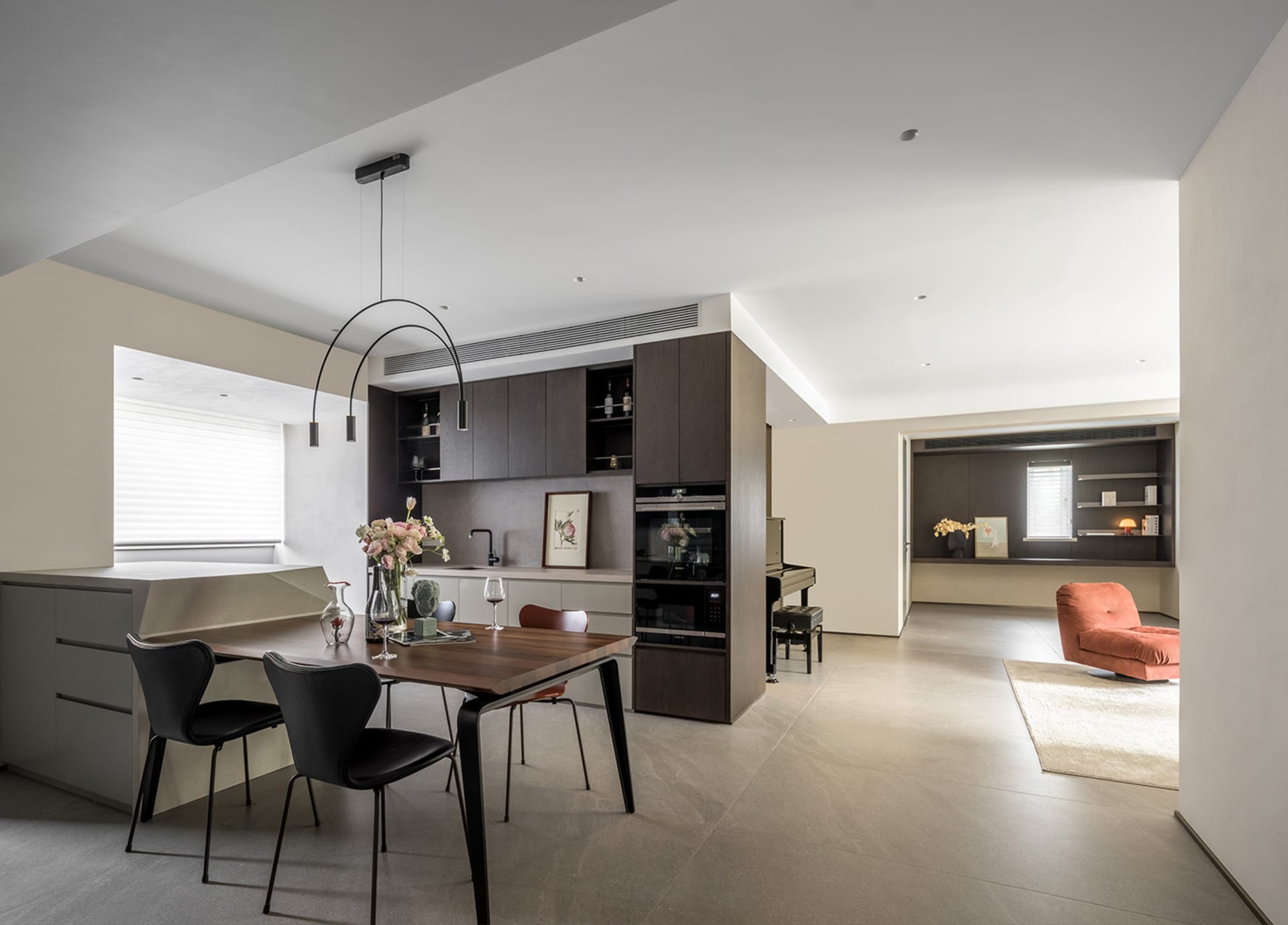 A modern apartment featuring concrete flooring and minimalist design.