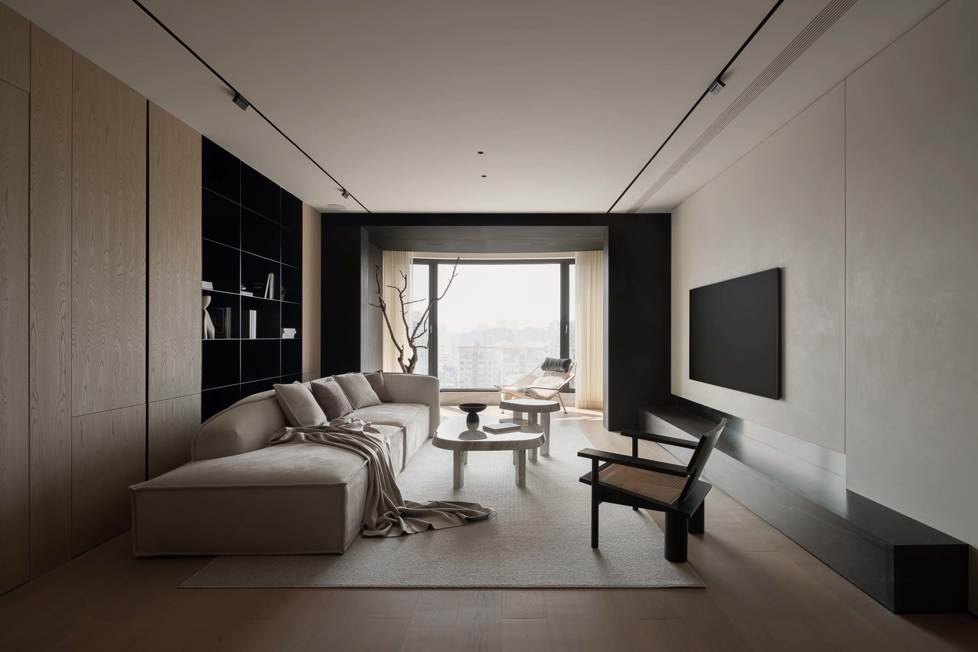 A minimalist living room with wooden paneling, featuring a sofa, coffee table, and large window with city view.