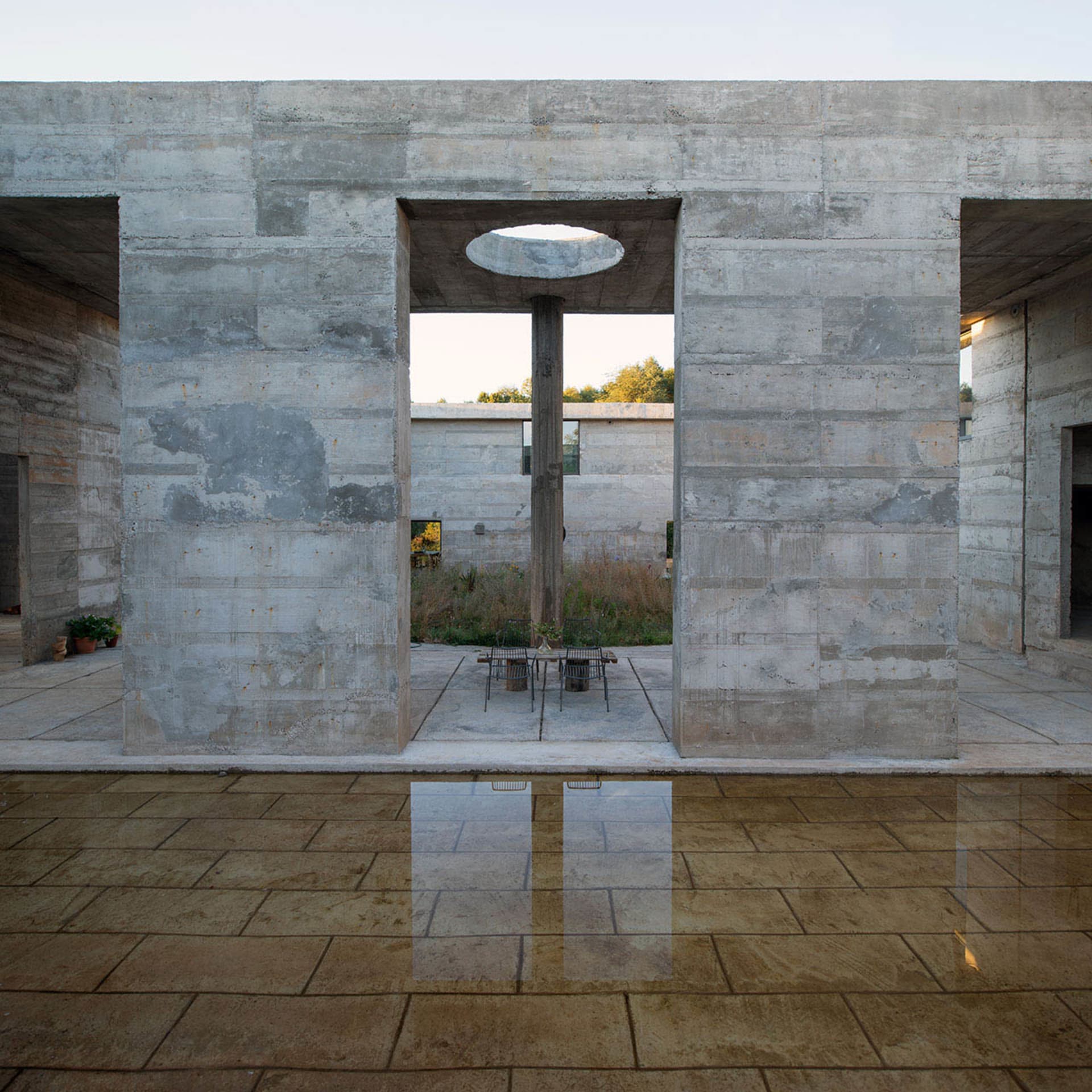 Modern space with concrete walls and a central column.