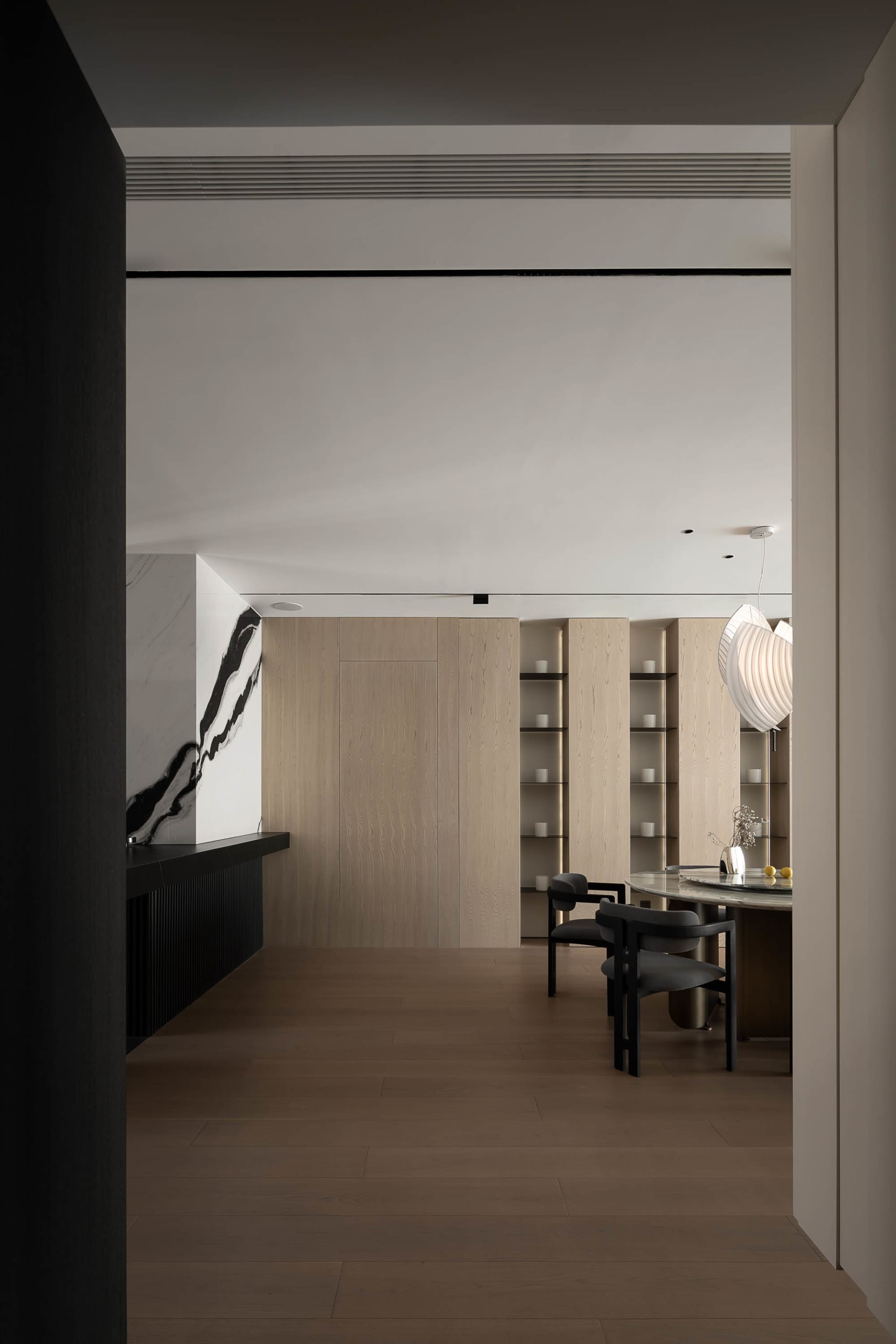 A modern interior featuring wood and marble materials