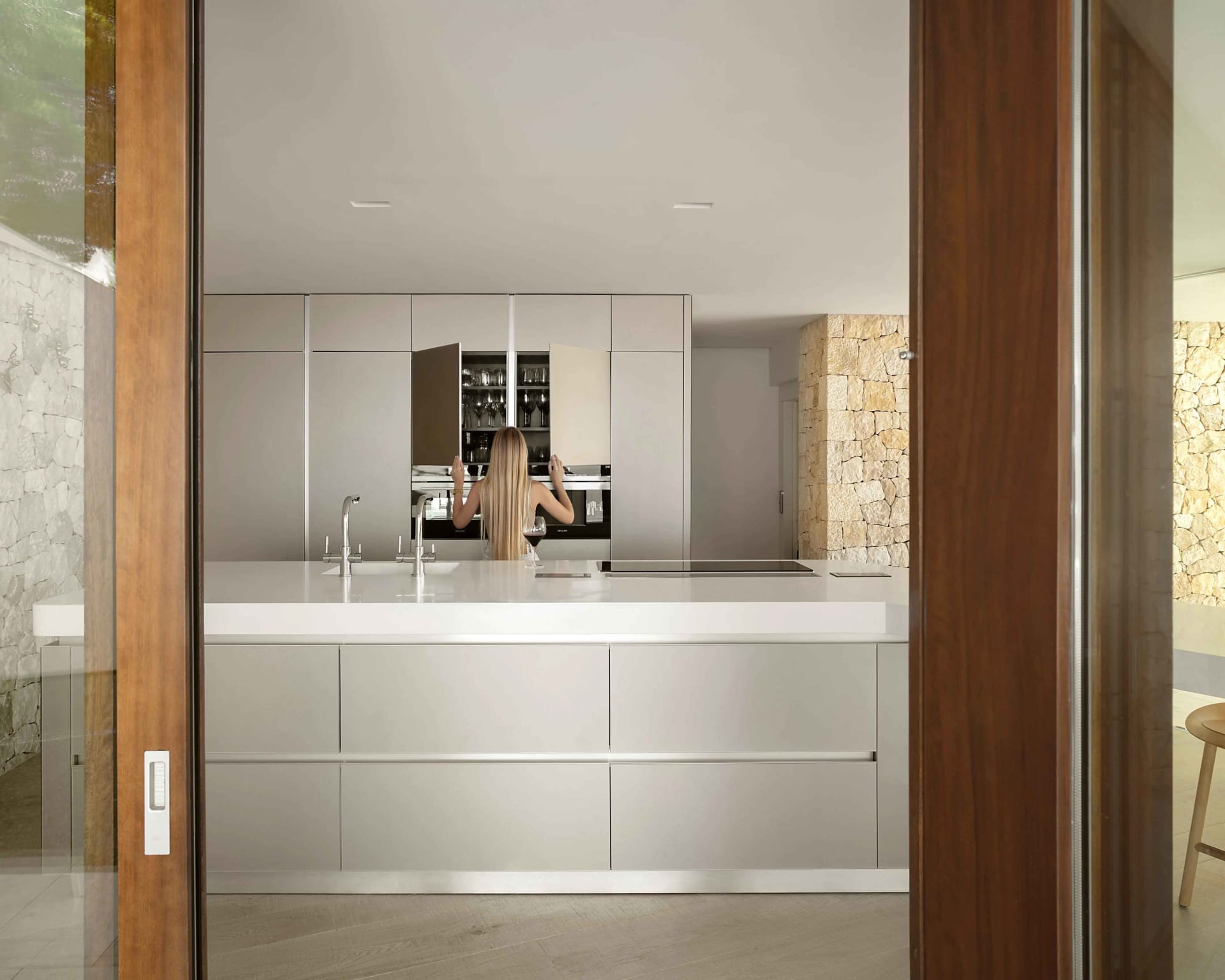 Innovative minimalist kitchen with sleek metallic cabinetry and integrated appliances.