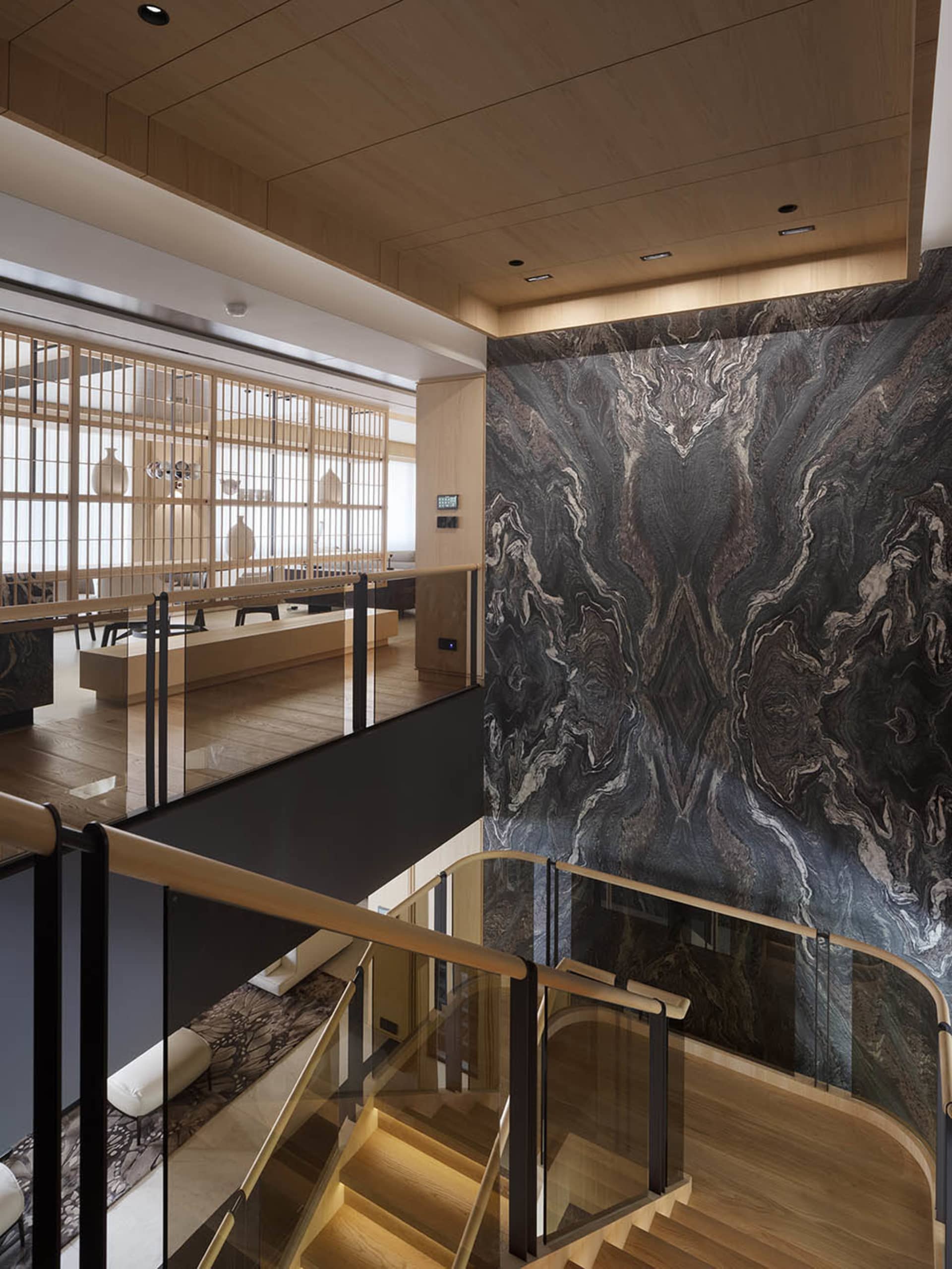 Modern residential sitting room featuring marble accents and wooden elements.
