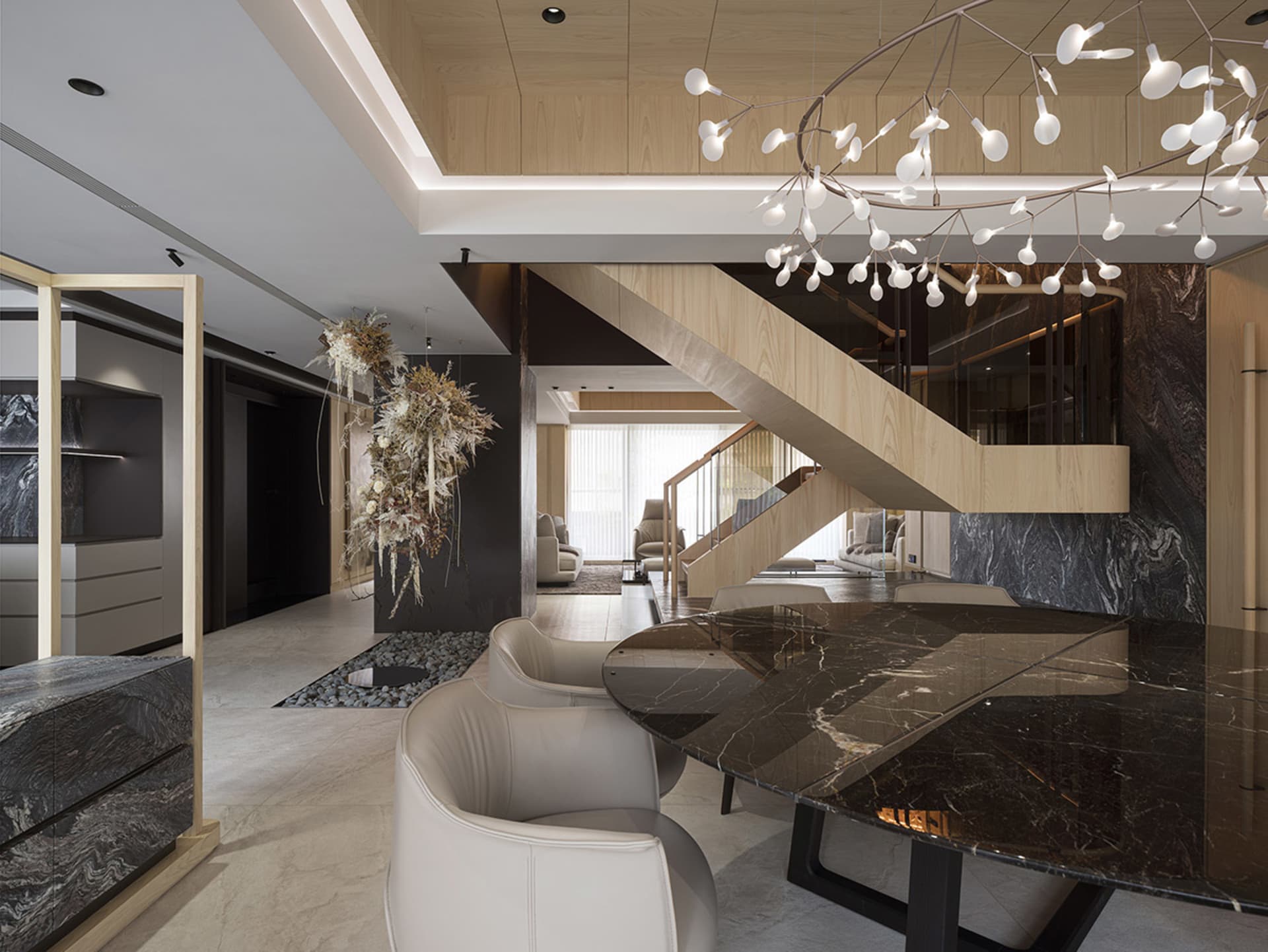 Modern living and dining area with marble, metal, and wooden elements.