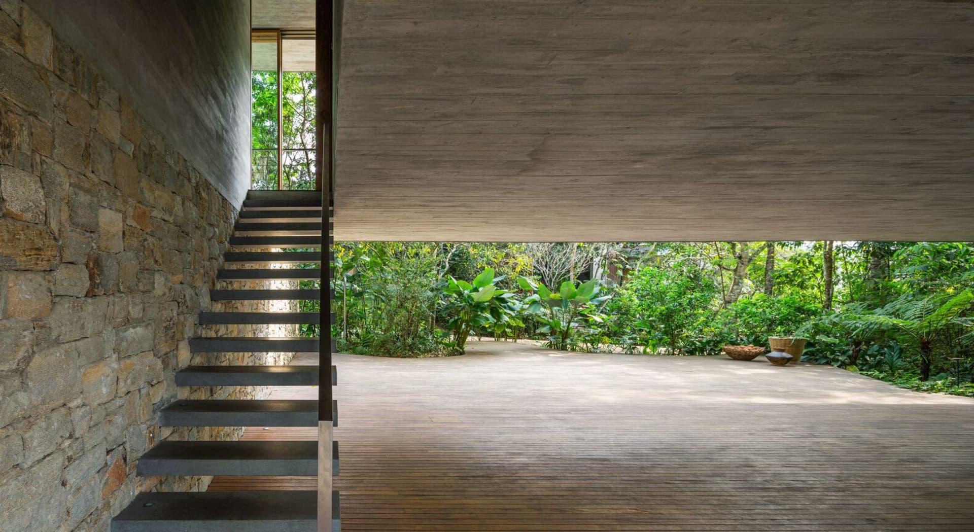 A modern interior space featuring stone and concrete materials.