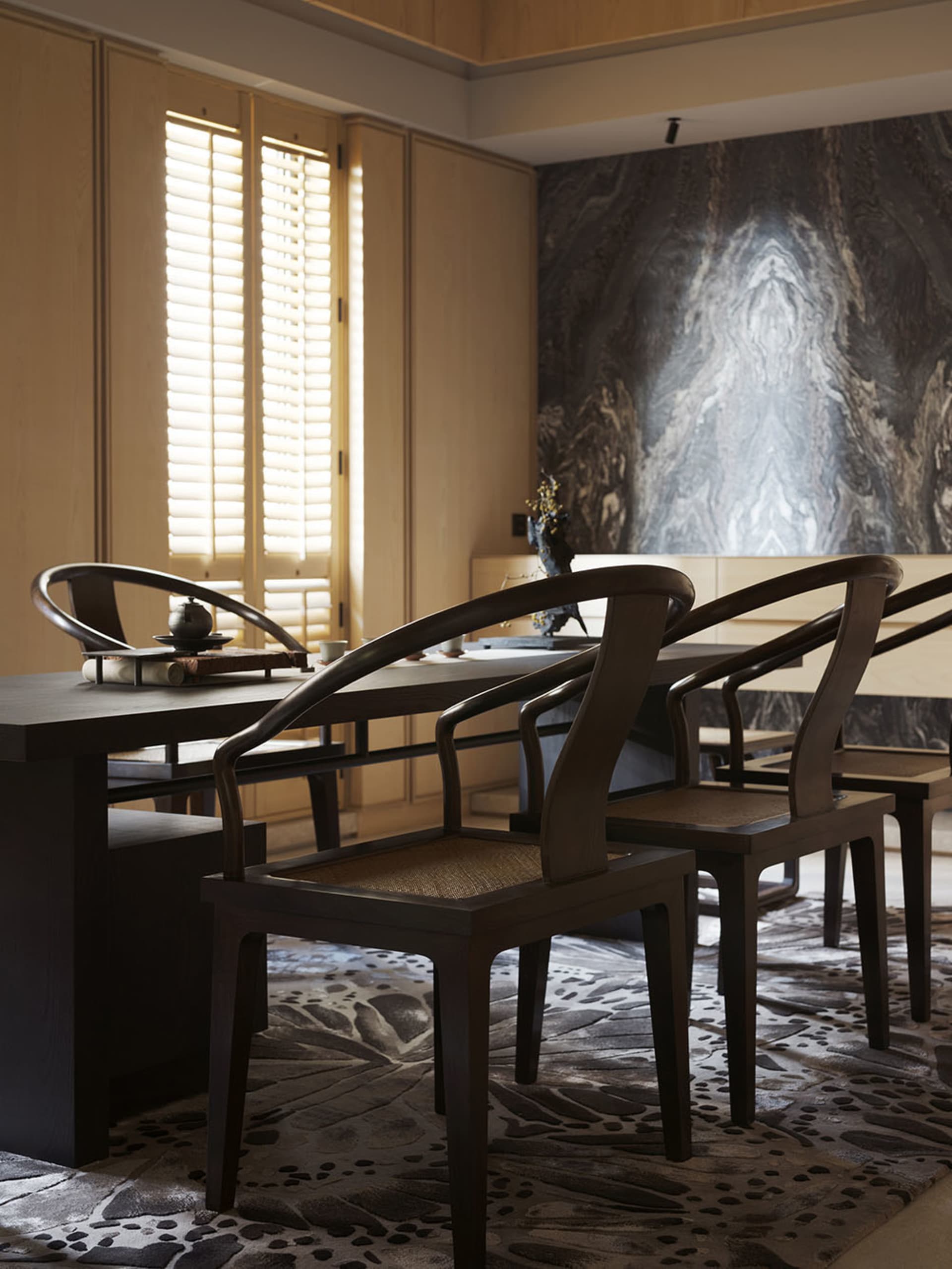 A modern dining room featuring wooden furniture with a contemporary design.