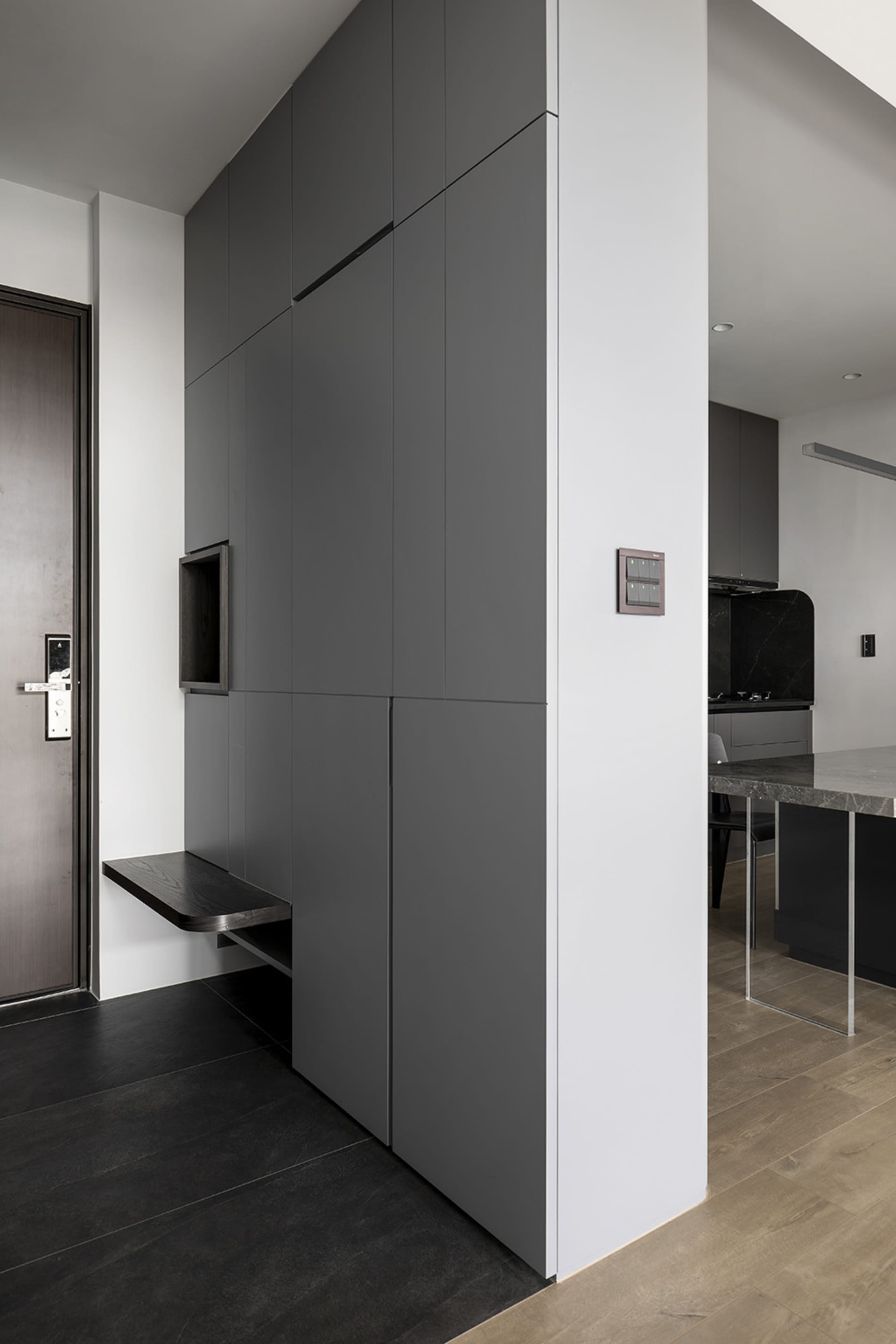 Modern kitchen featuring sleek, minimalist gray-veneer cabinets and a textured countertop.