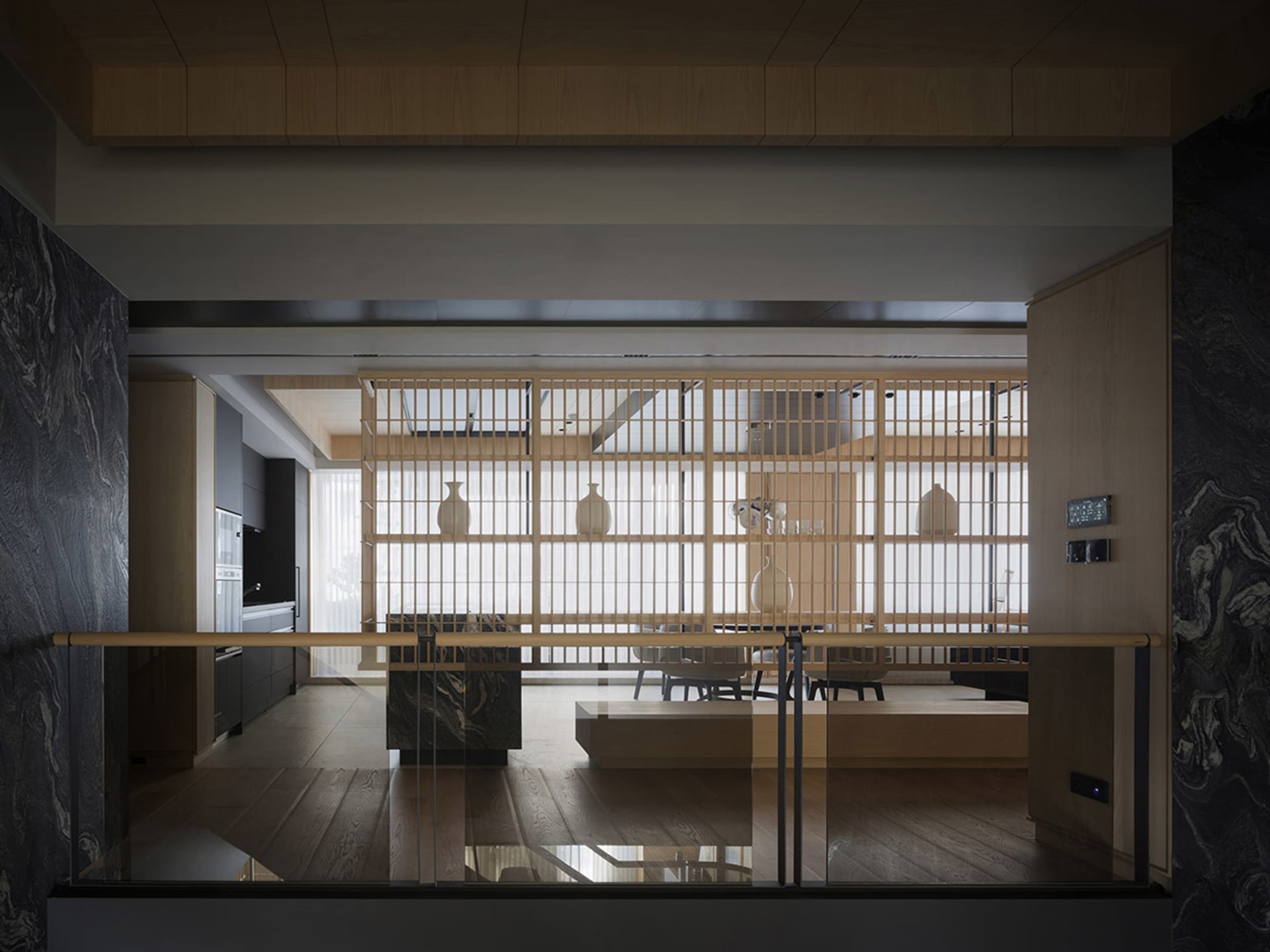 Modern living room featuring marble accents and a glass partition.