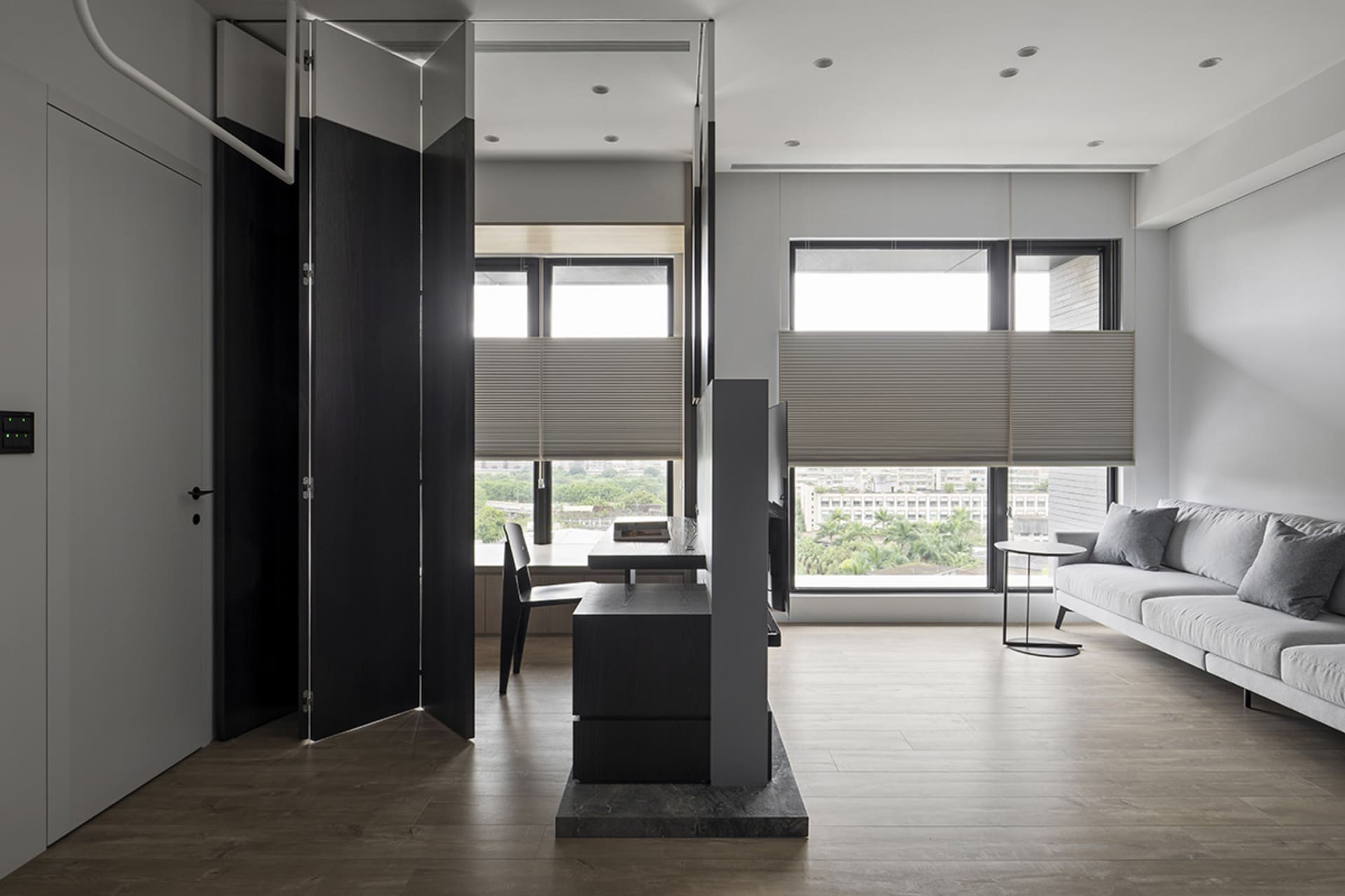 A modern living room featuring glass, wood, and fabric materials with a minimalist design.