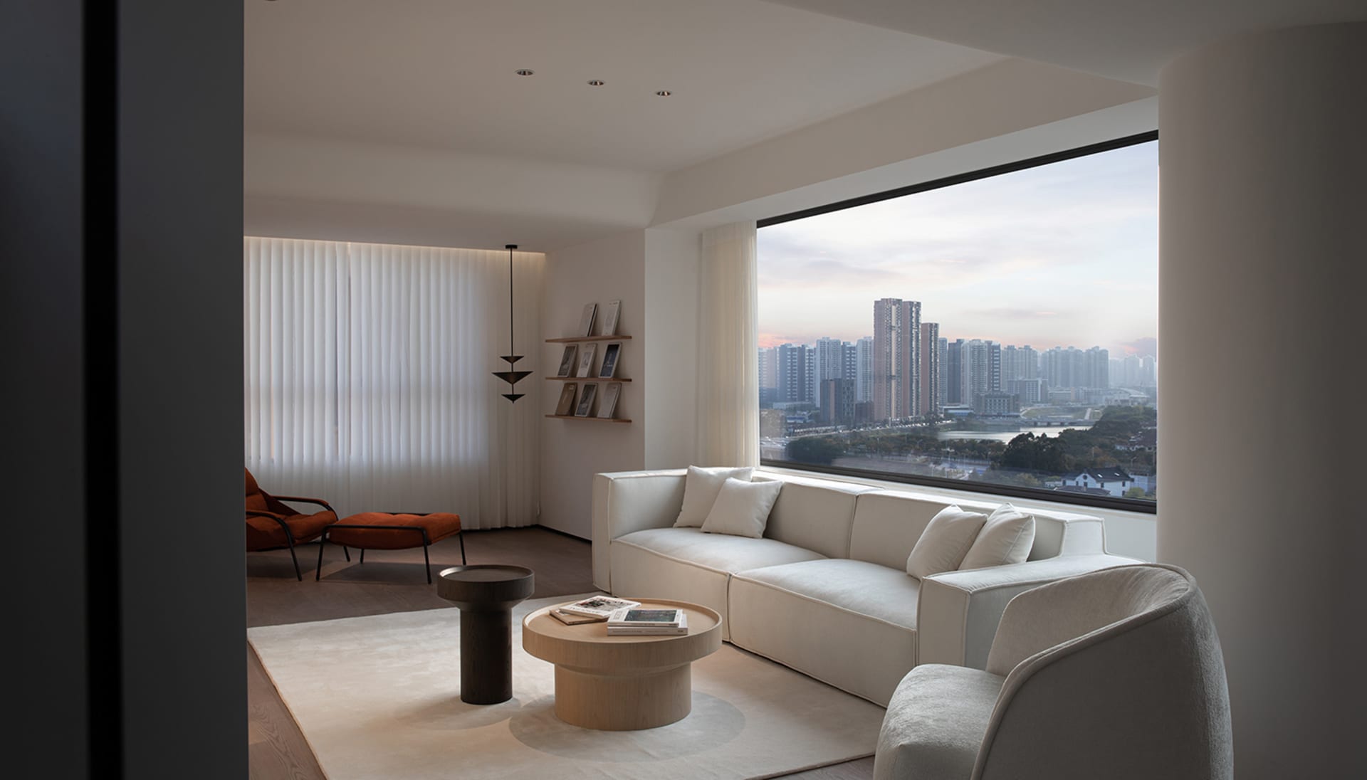 Modern minimalist living room with clean lines, white sofa, and cityscape view through large window.