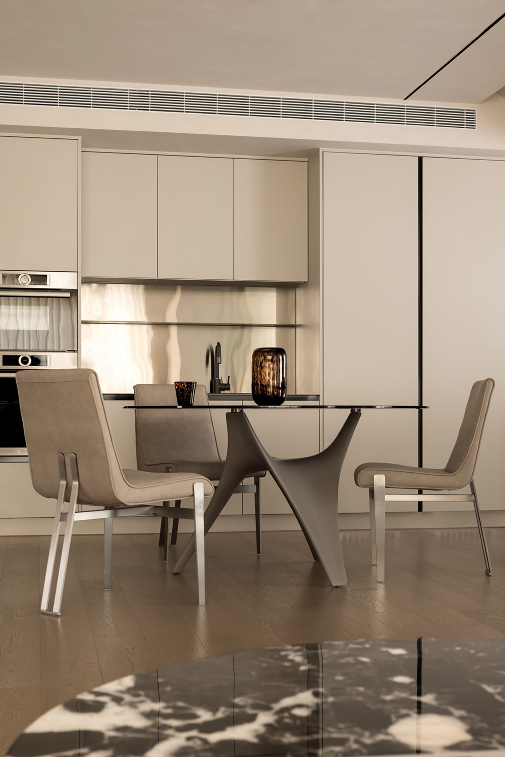 A modern, neutral-colored kitchen with a glass dining table and minimalist design.