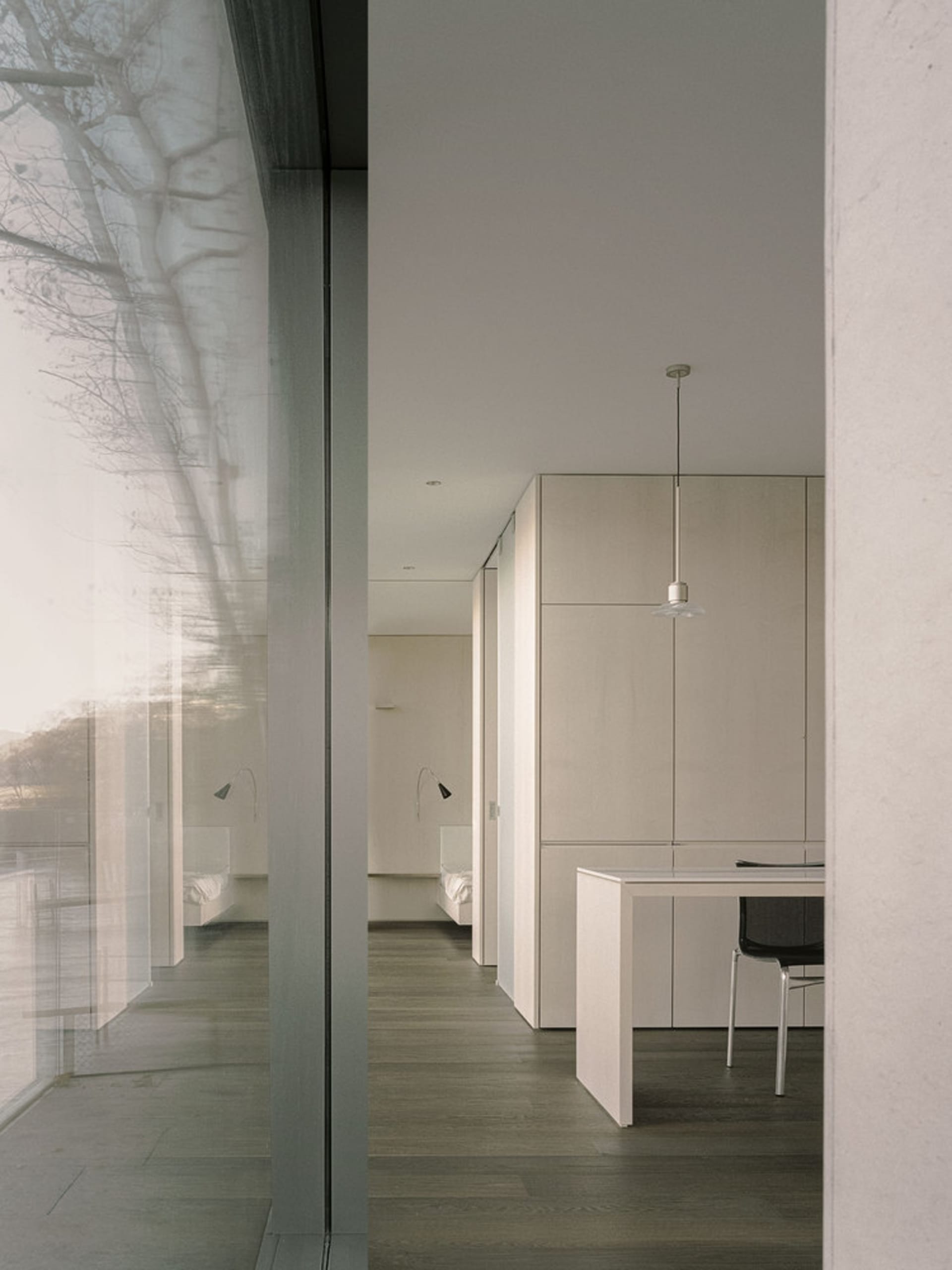 A modern office space featuring a combination of wood, glass, and metal materials.