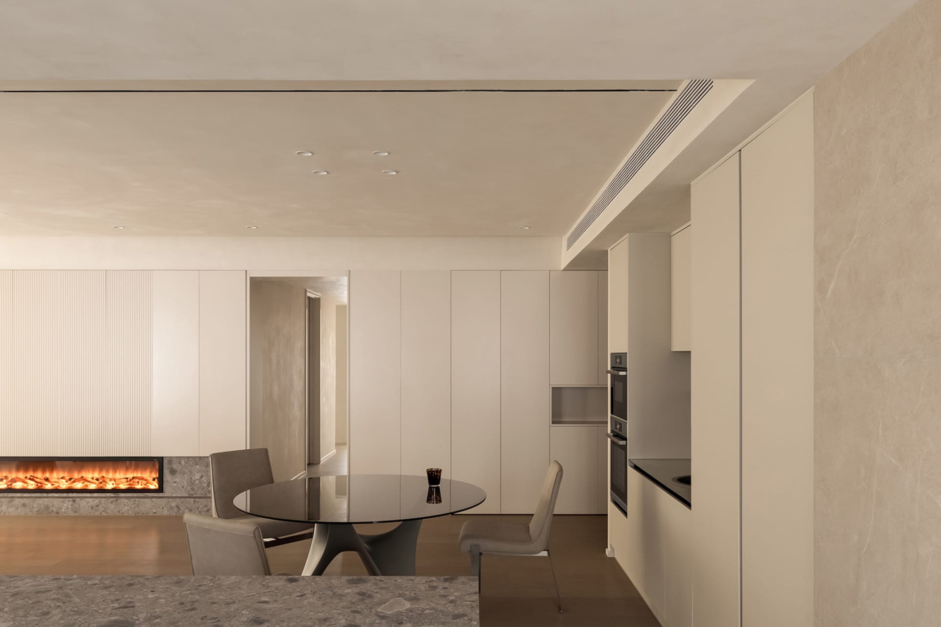 Modern residential kitchen with minimalist design and light-colored materials.