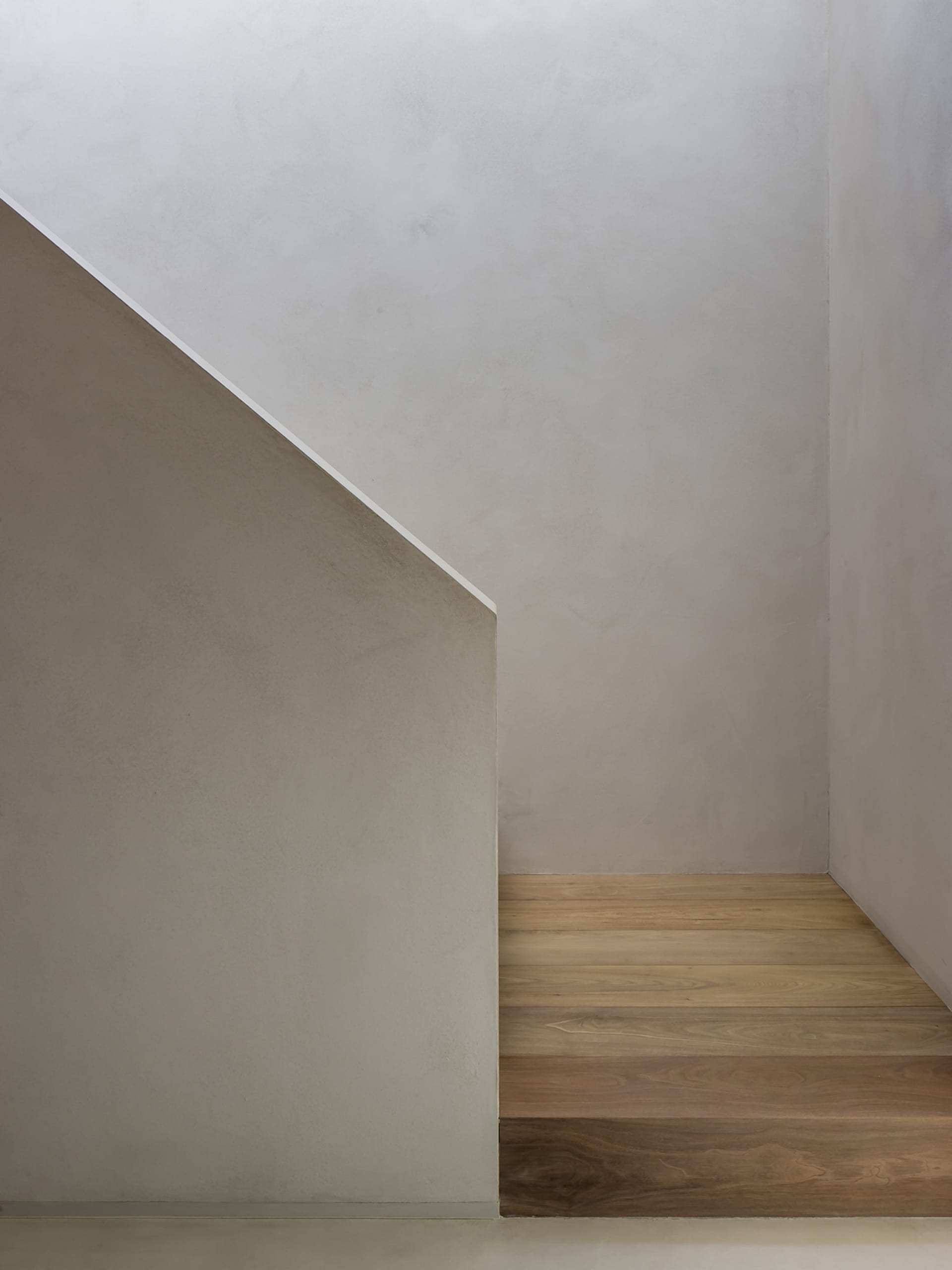 Minimalist modern stairwell clad in concrete