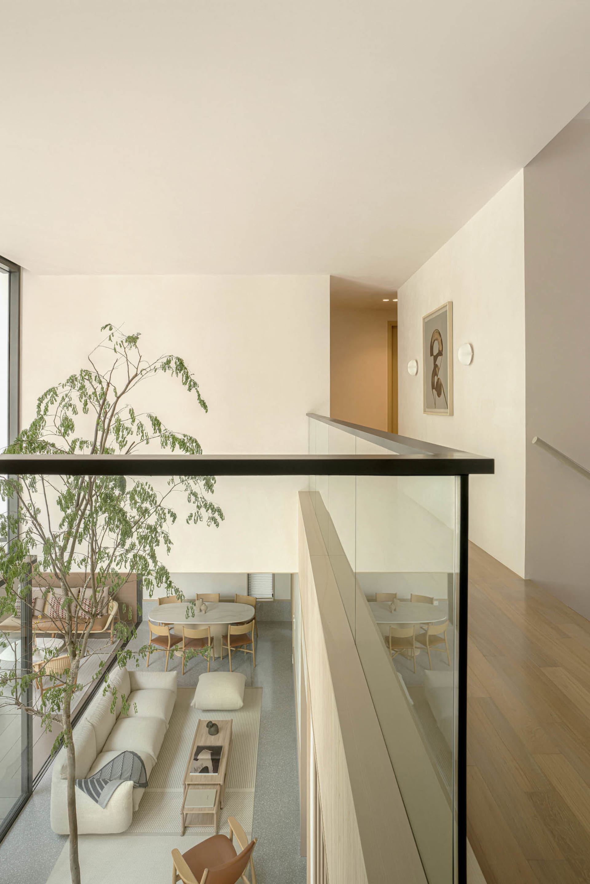 A minimalist living space showcasing a terrazzo floor and furniture.