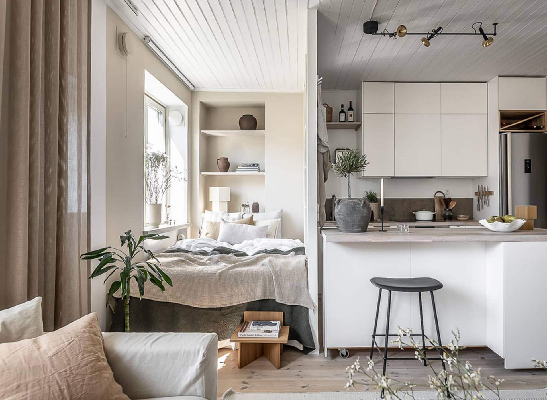 A minimalist apartment with neutral tones and modern furniture.