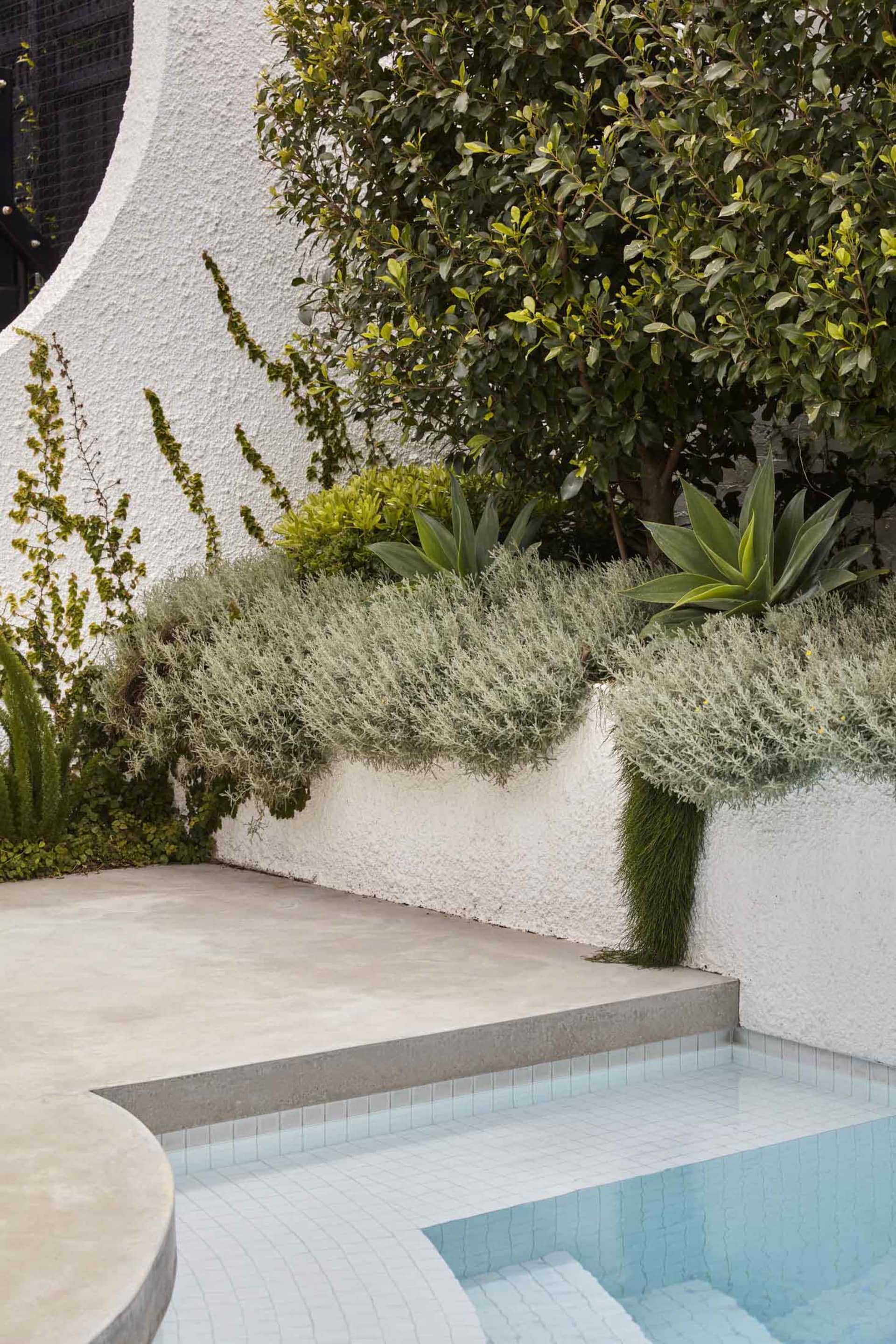 Modern minimalist outdoor retreat featuring concrete and tile surfaces.