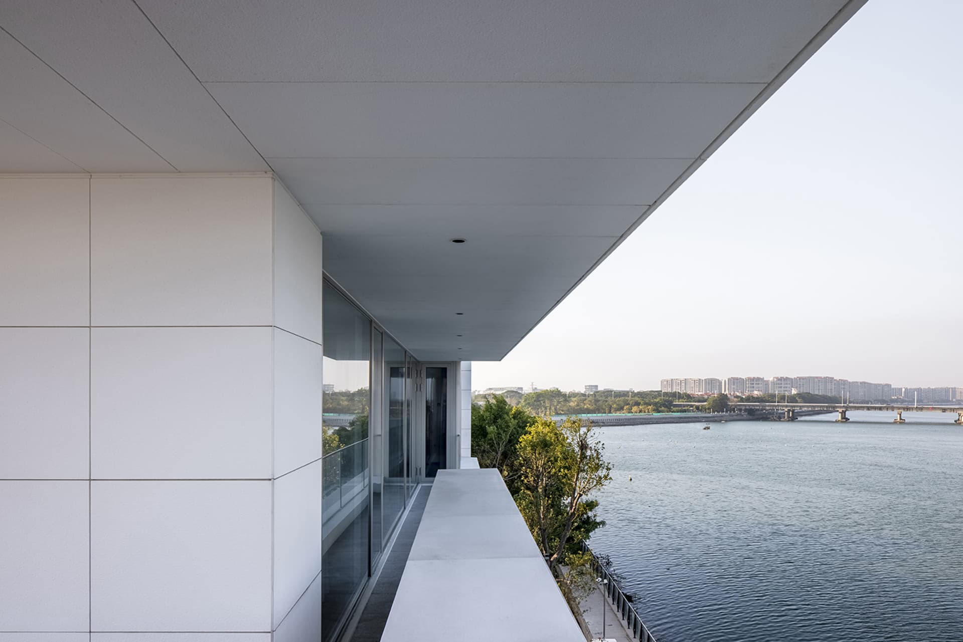 Modern house with glass terrace overlooking the water.