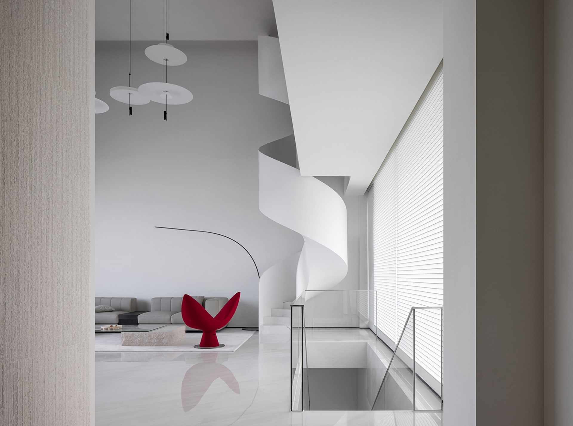 A minimalist interior design featuring a white marble staircase.
