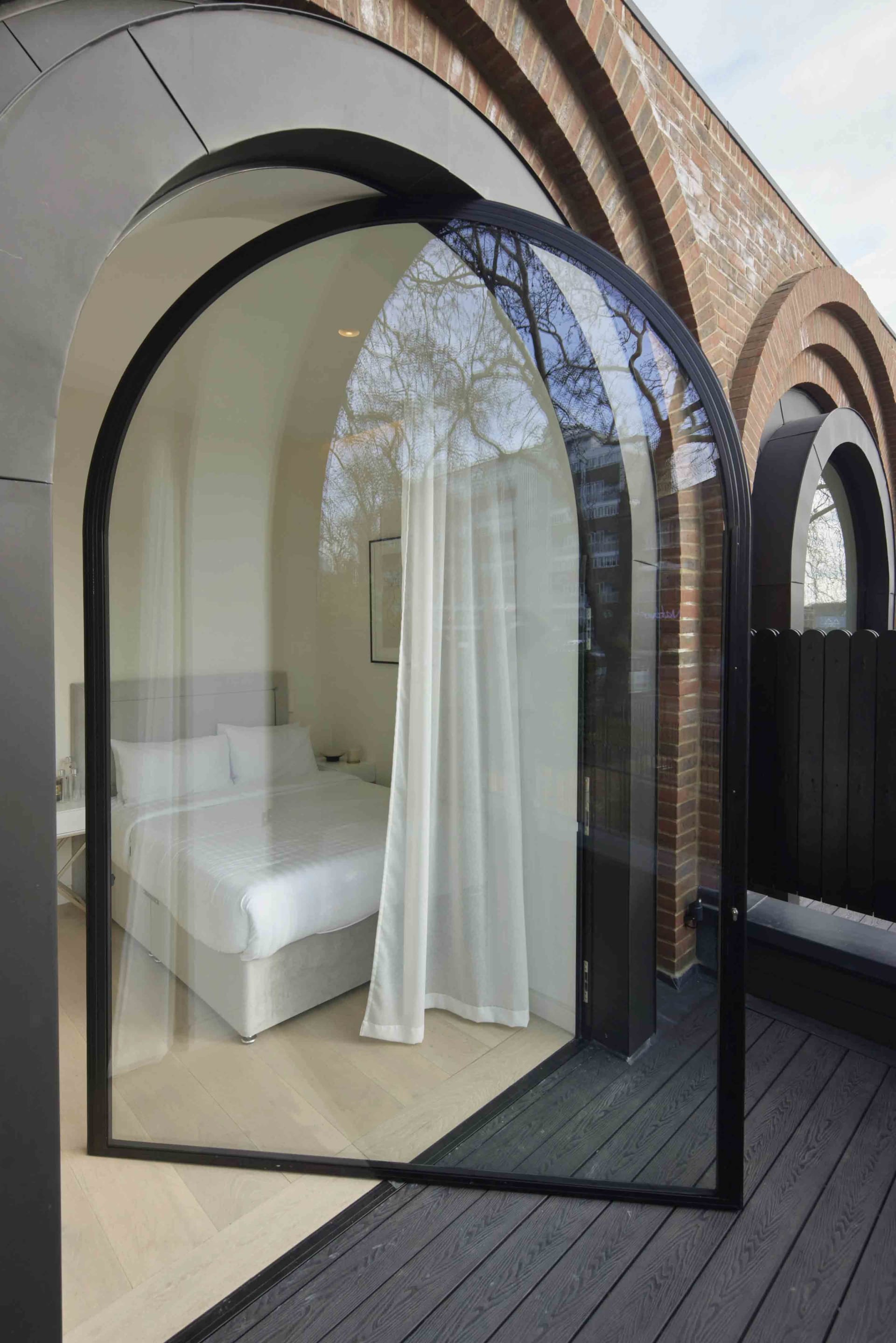 Modern architectural design featuring glass, brick, and wooden materials.