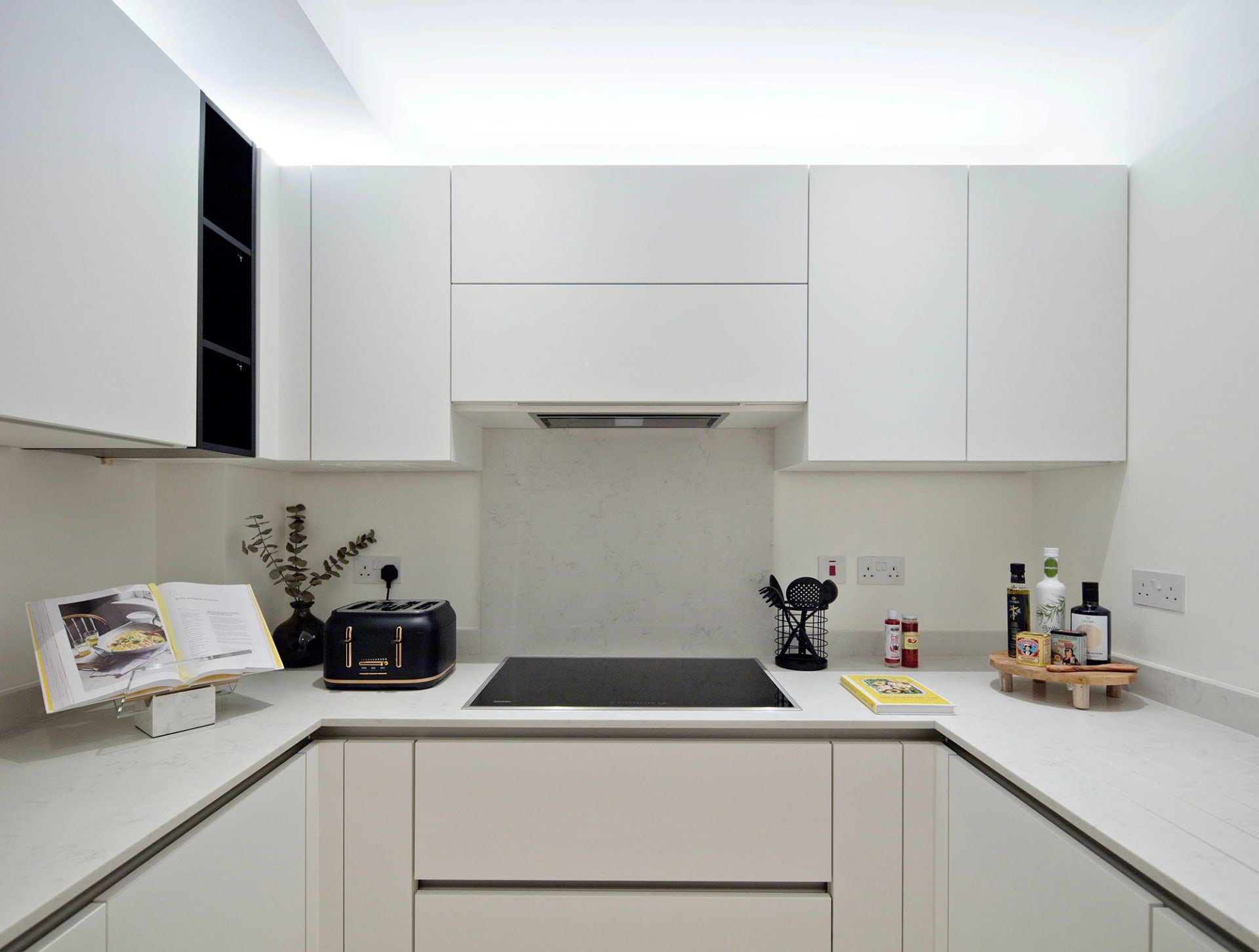 Modern, white kitchen cabinets with a minimalist design.