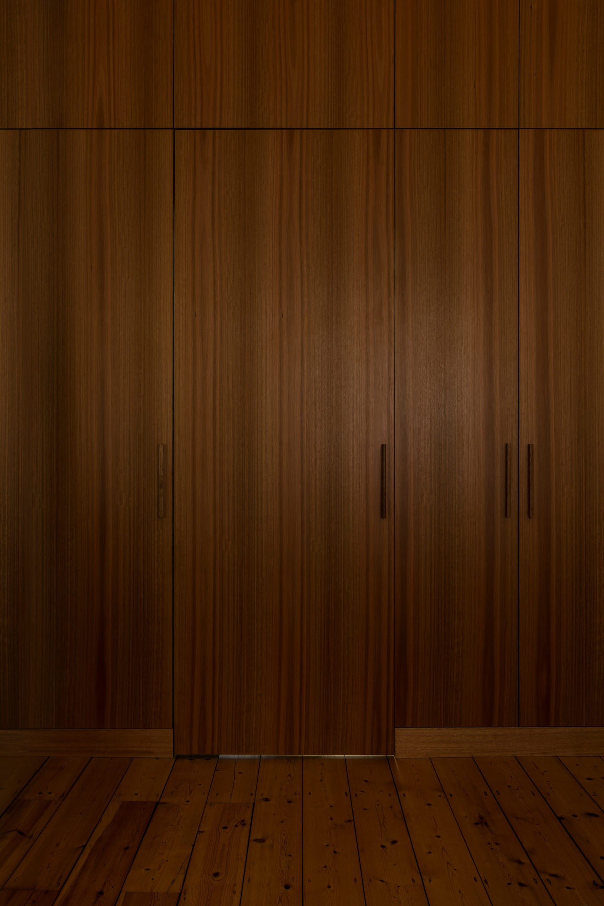 A modern interior design featuring dark wood cabinets.