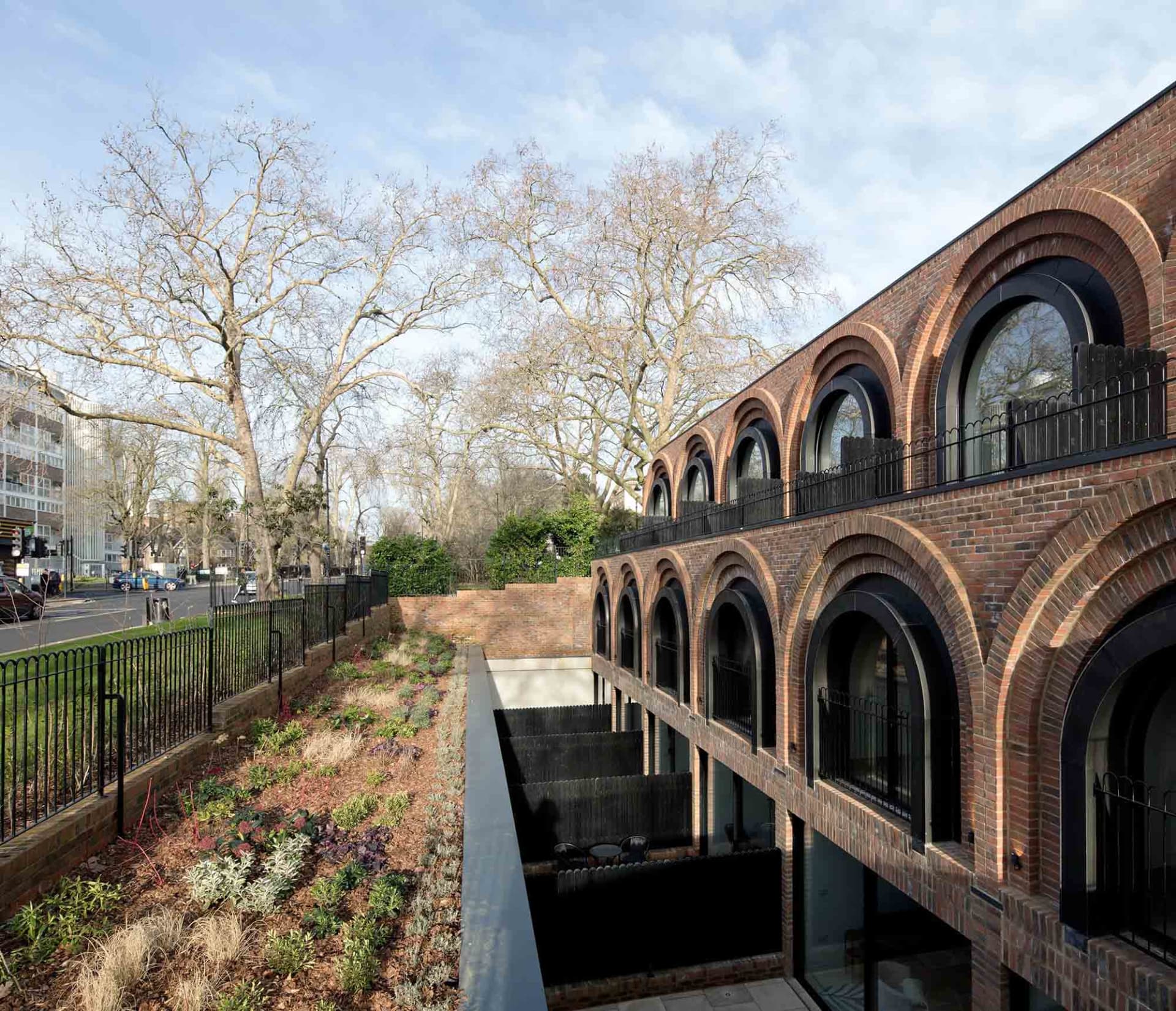 A modern building with arched windows and a brick facade.