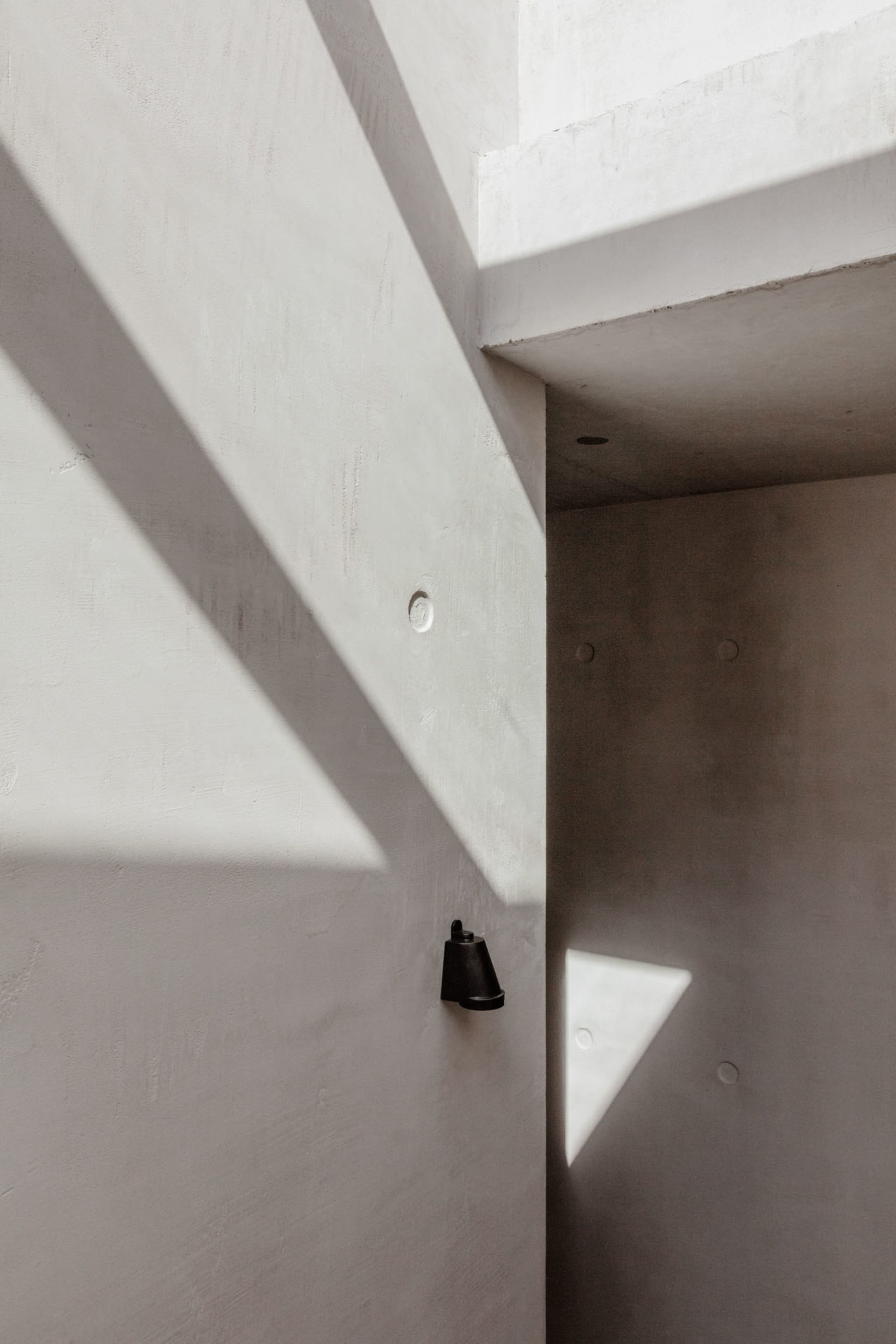 Modern minimalist interior with clean concrete walls and geometric forms