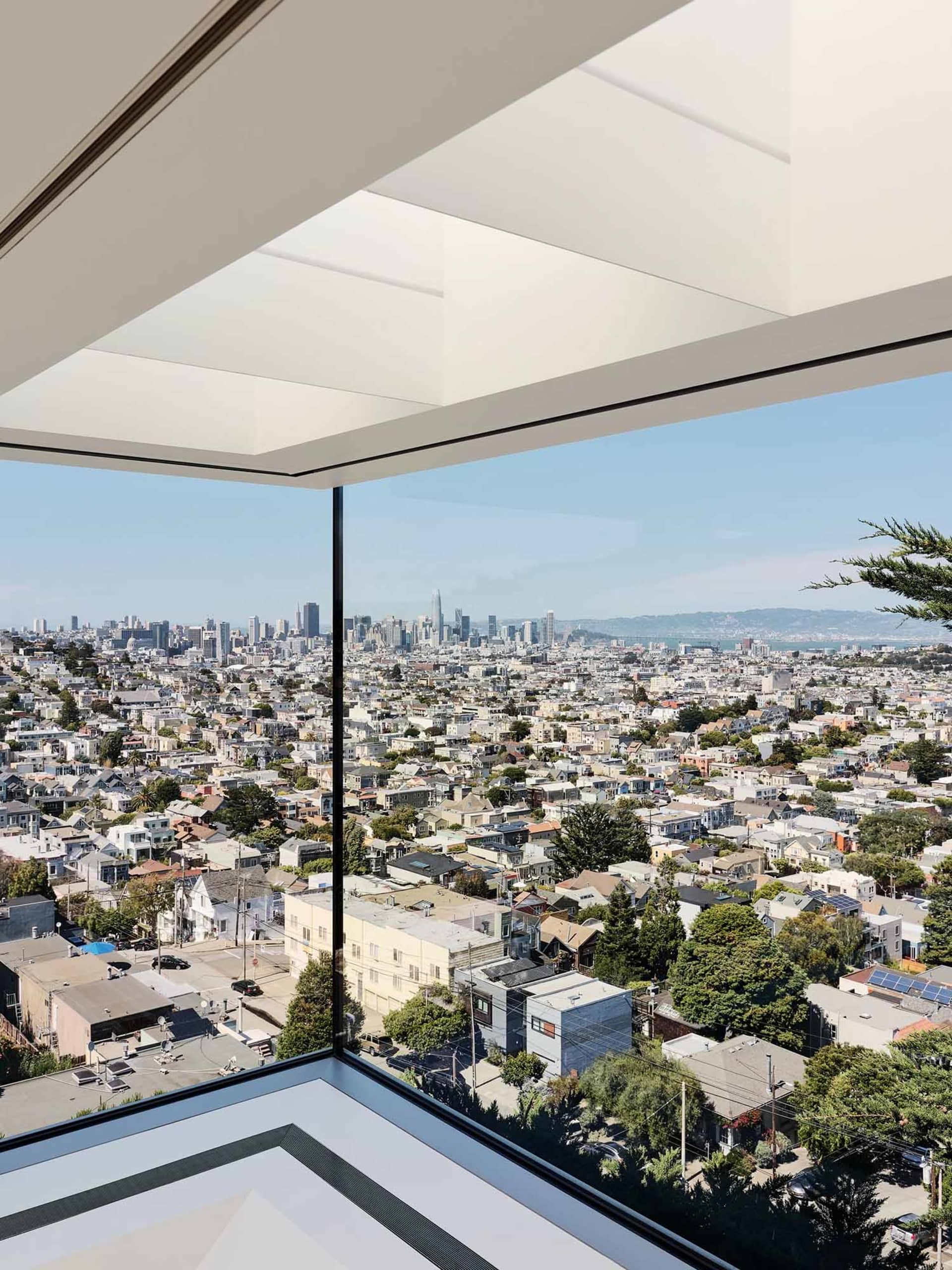 A glass window view of a modern cityscape on a clear day.