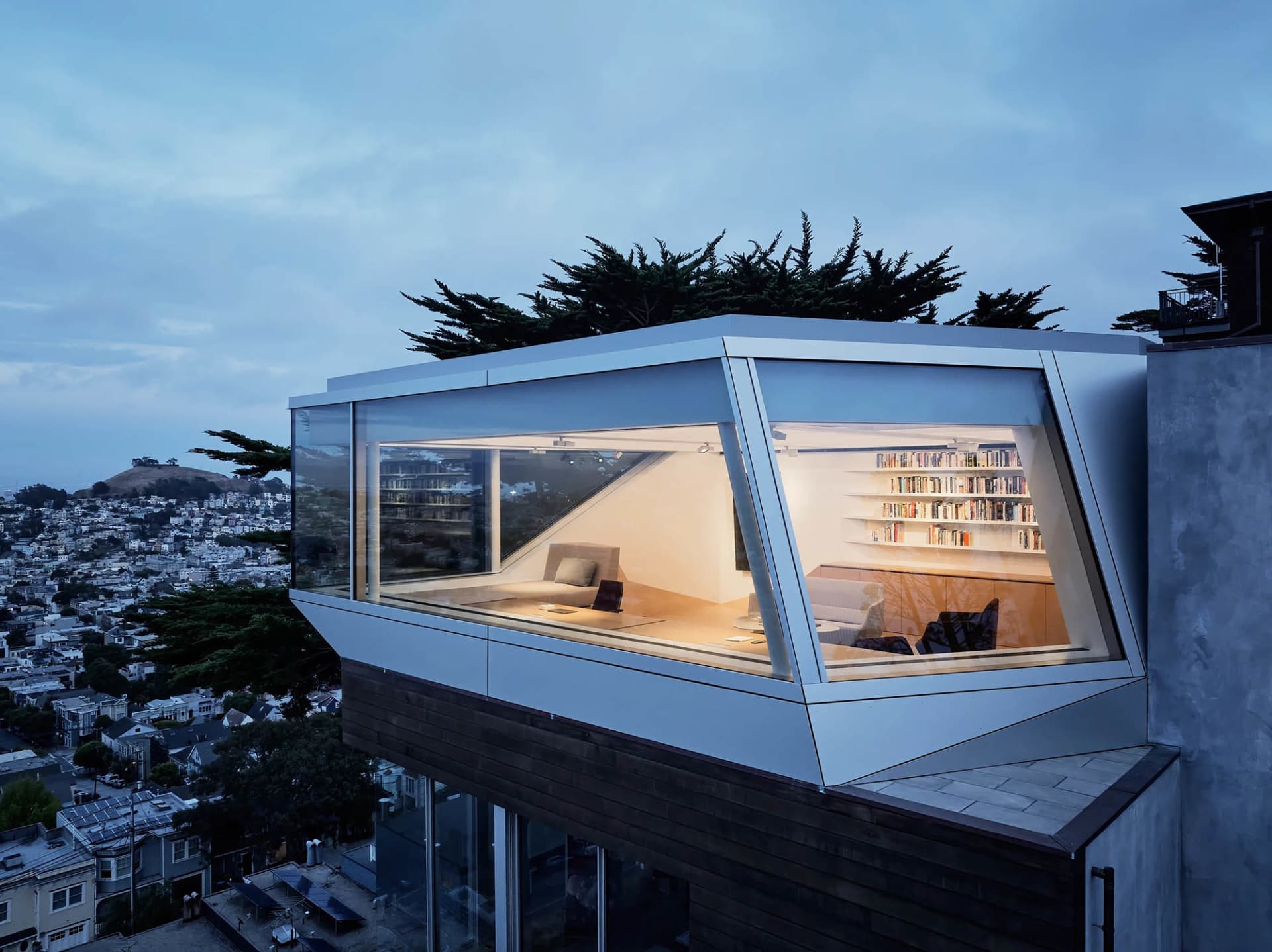 A modern home office exterior featuring glass walls and a contemporary design.