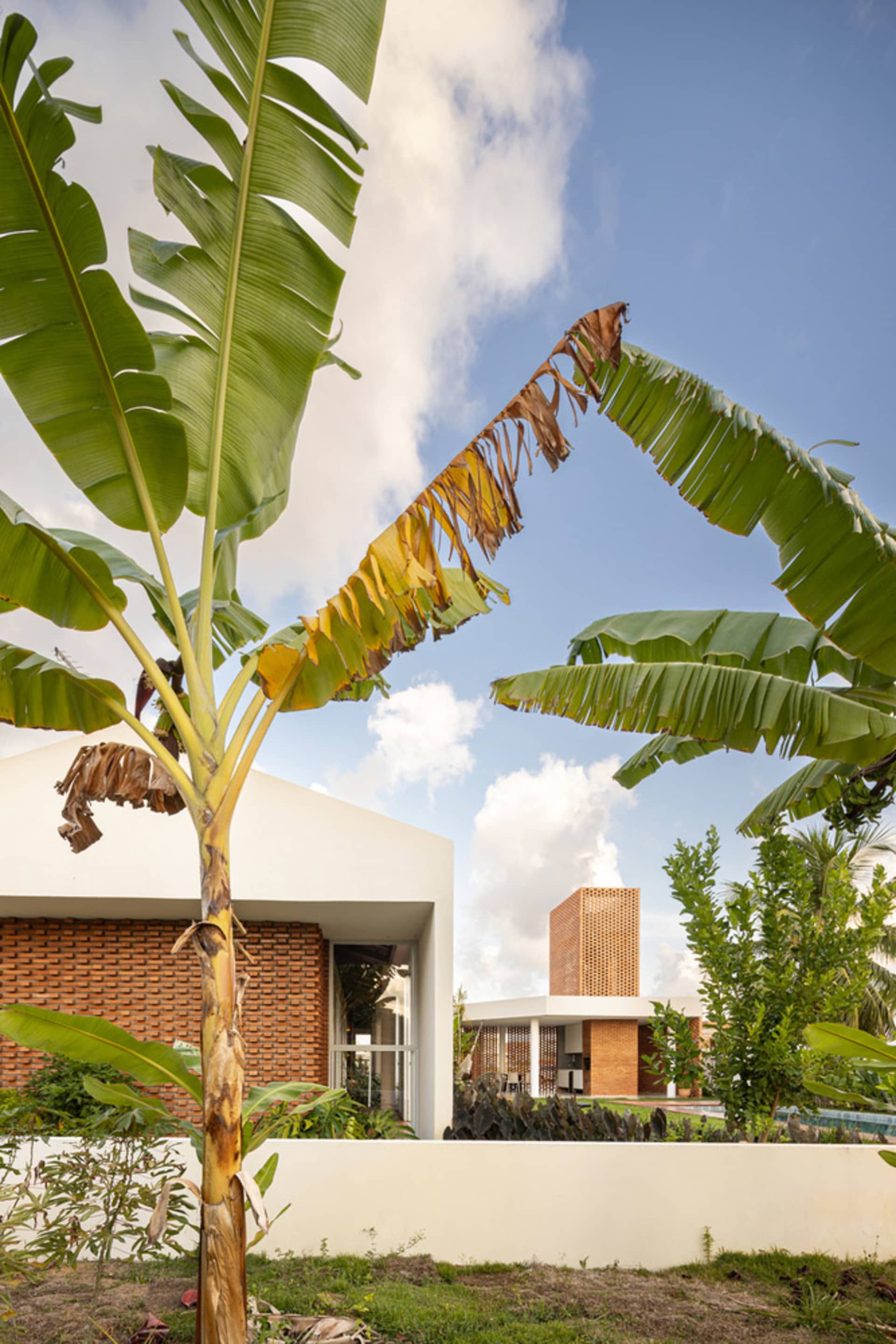 Modern residence featuring concrete and clay brick exterior.