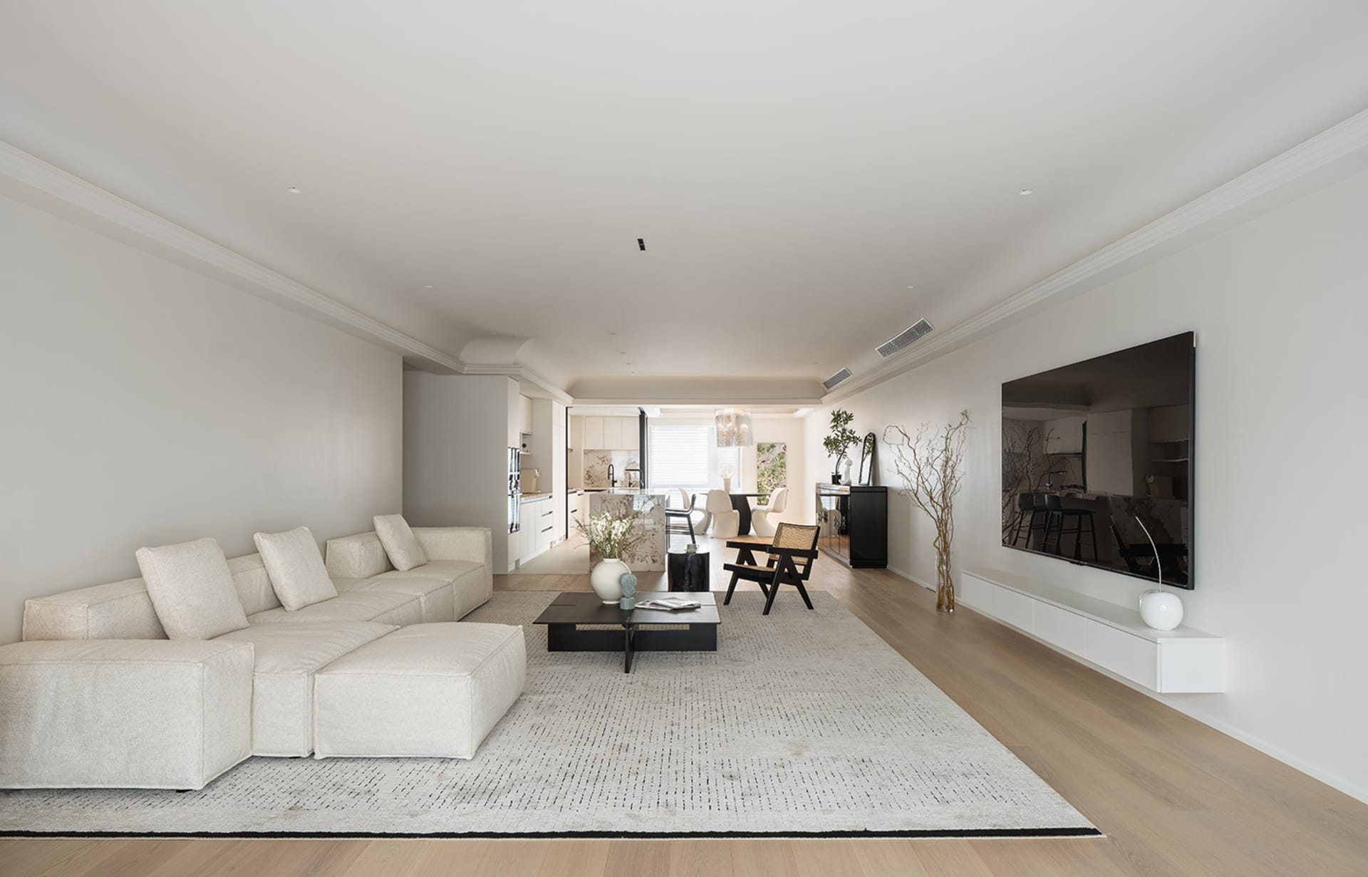 A modern minimalist living room with a neutral color palette.