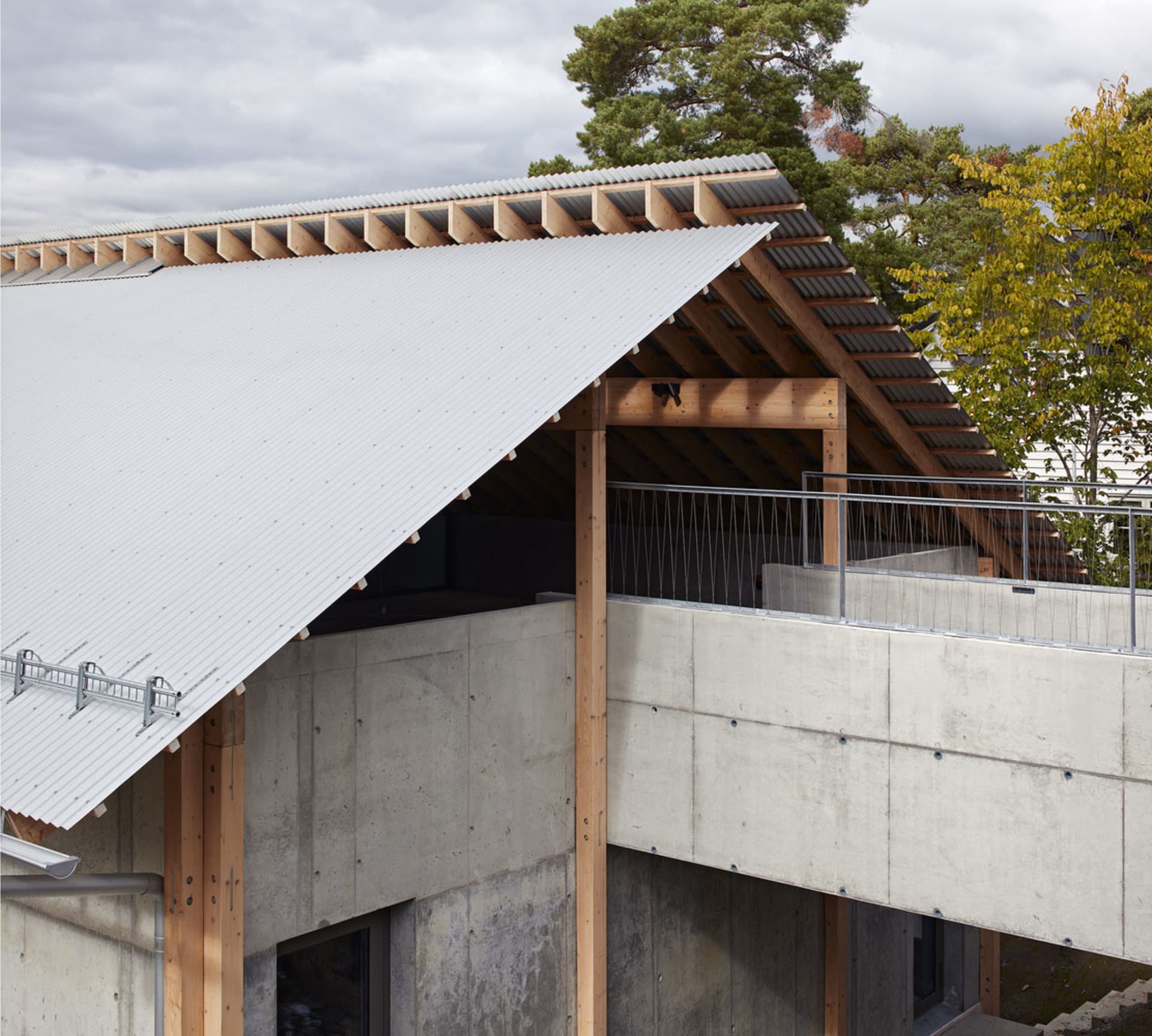 Modern building exterior with metal, concrete, and wood materials.