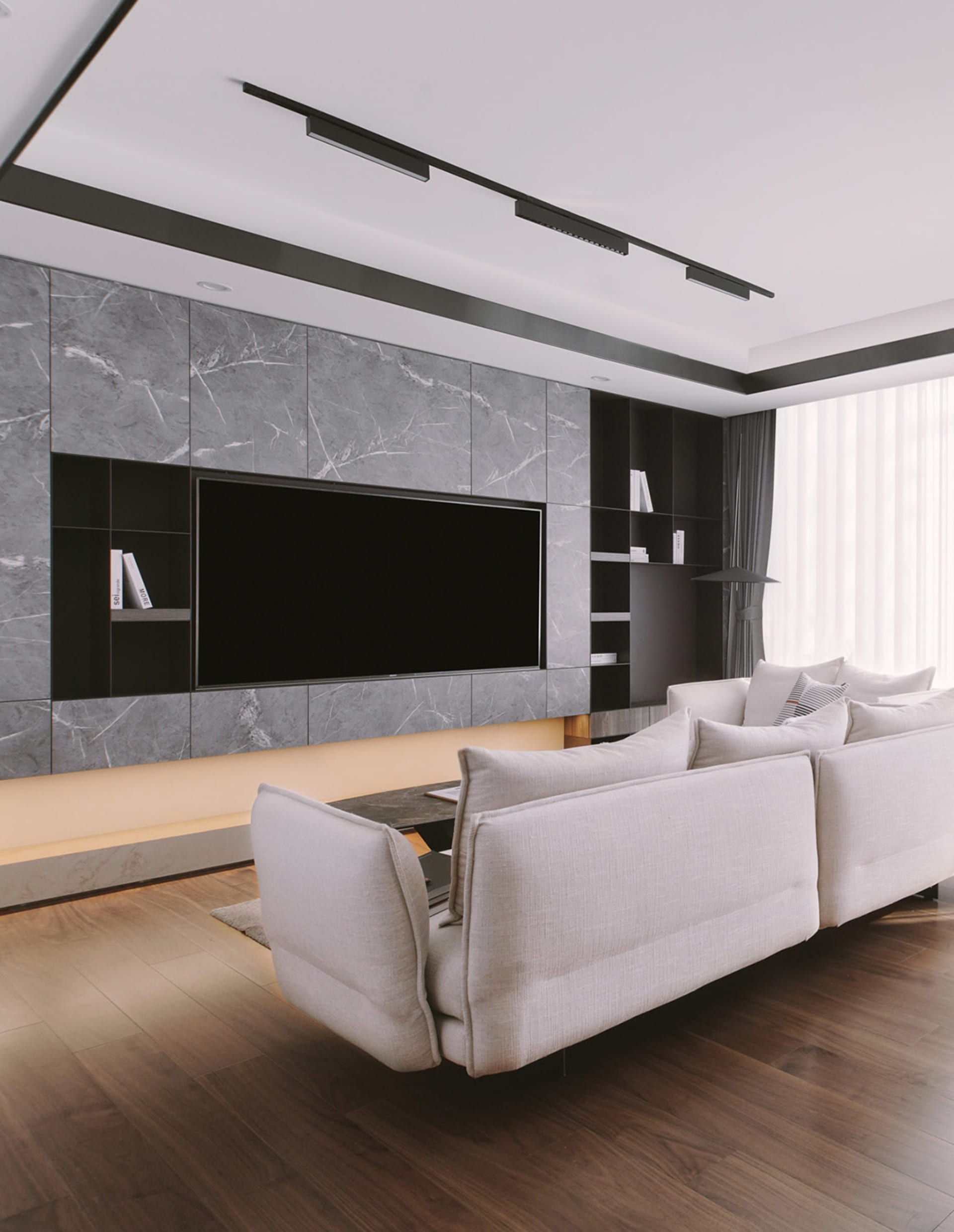 Minimalist living room with marble accent wall and concrete floor