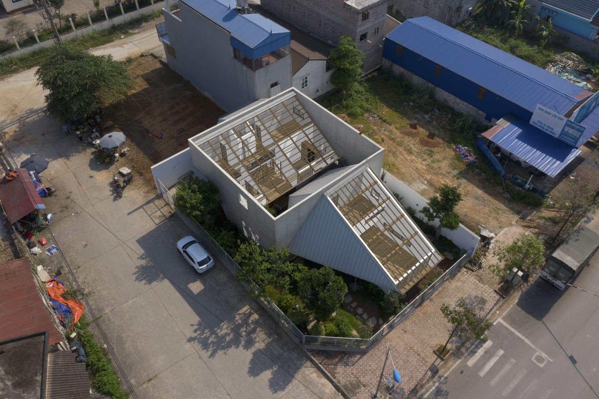 A modern building exterior constructed with concrete, glass, and aluminum materials.