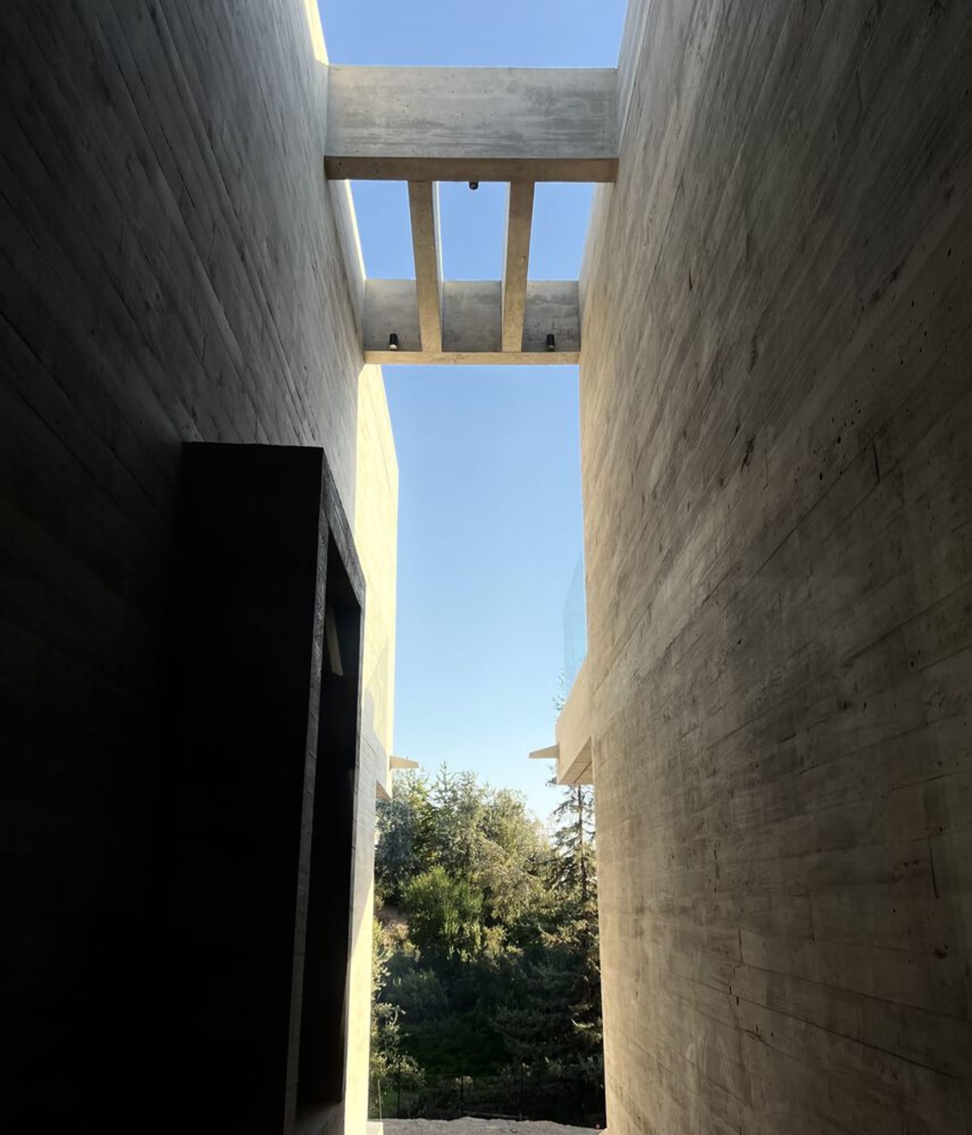 Modern architectural space featuring concrete walls and glass elements.