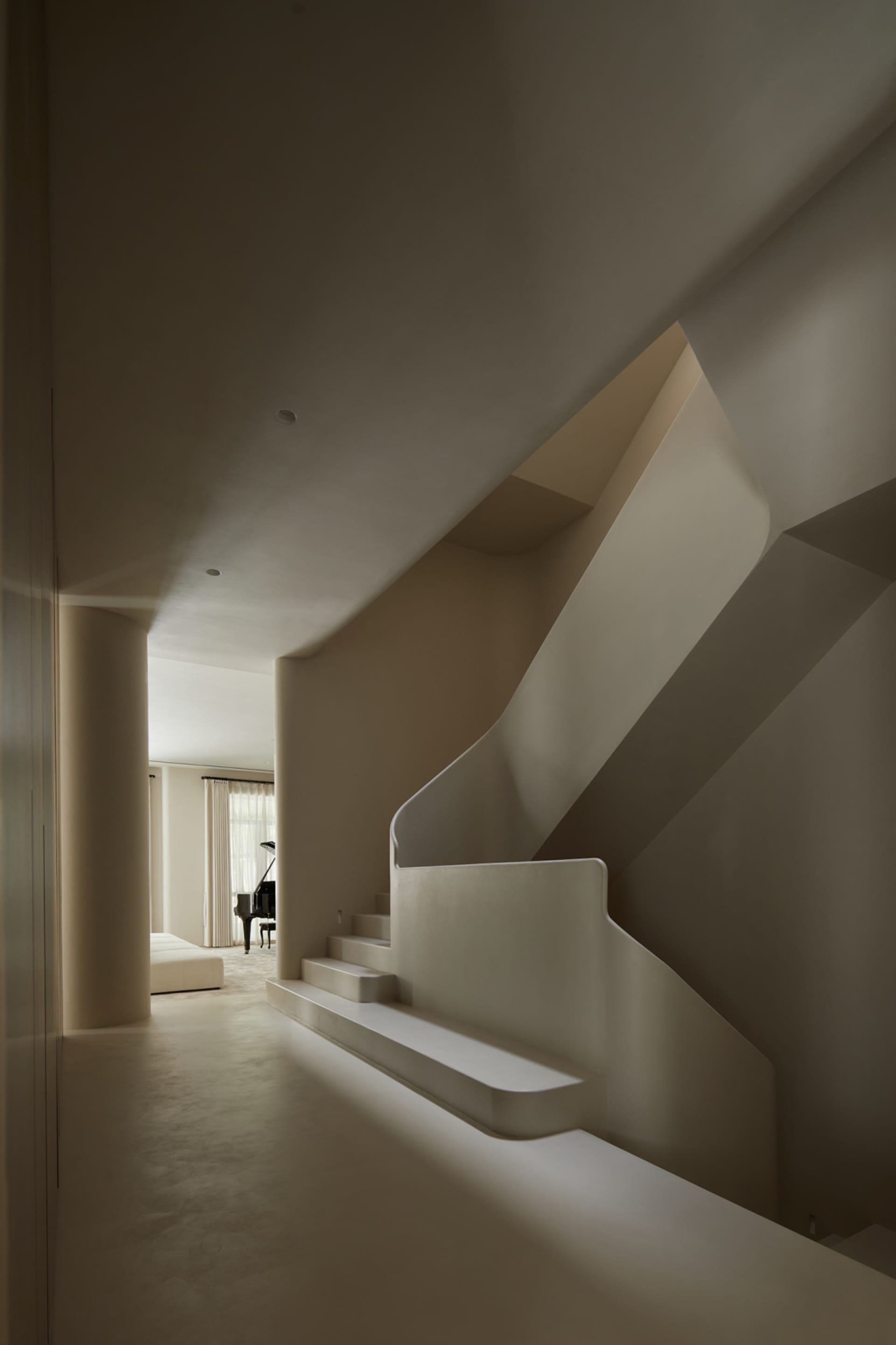 A minimalist staircase constructed from white concrete.