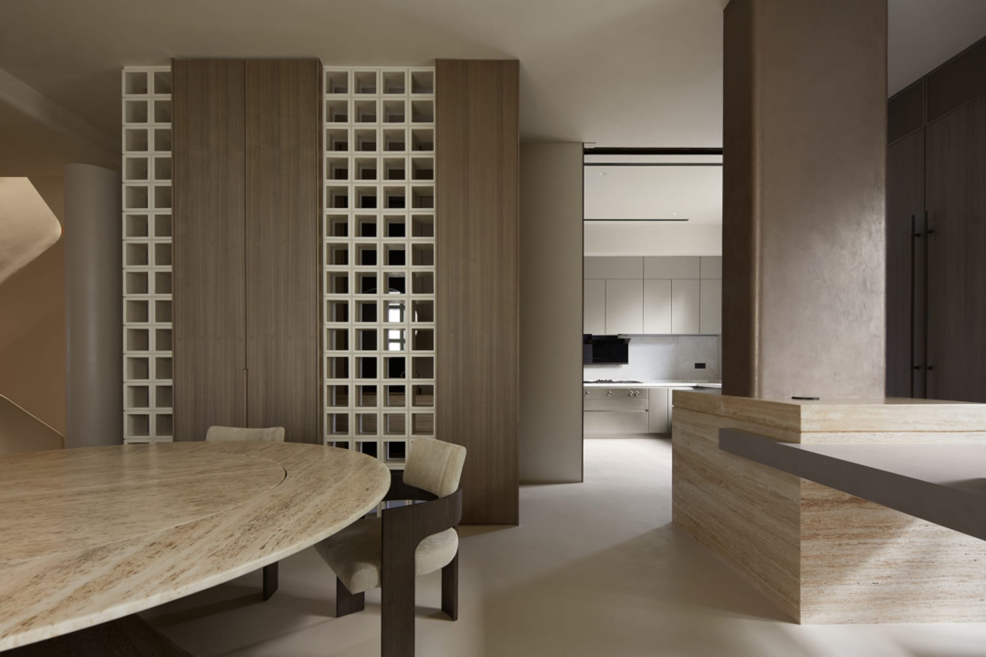 Modern residential space featuring marble countertops and wooden cabinets.