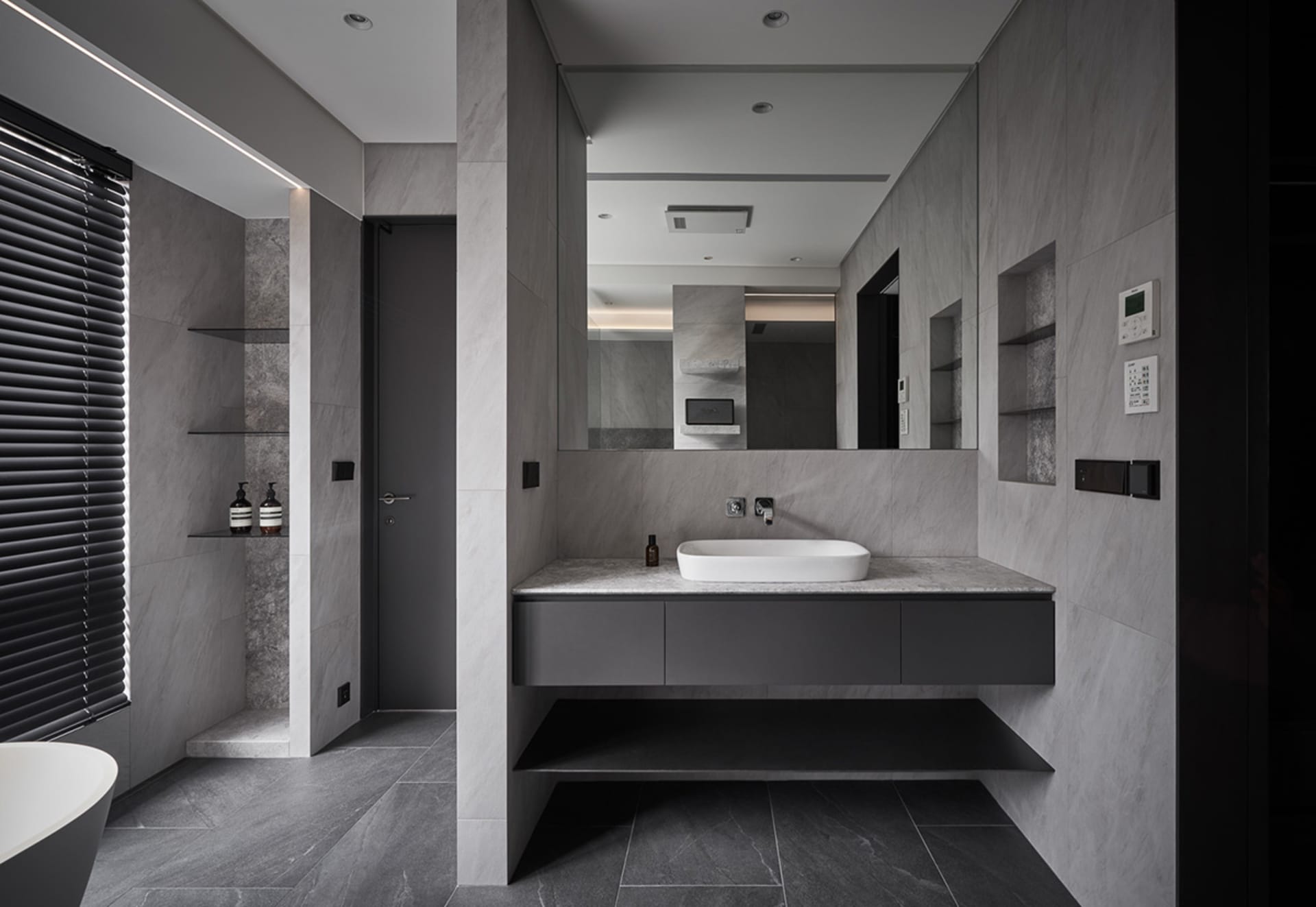 Modern bathroom with a sleek marble countertop and minimalist design.