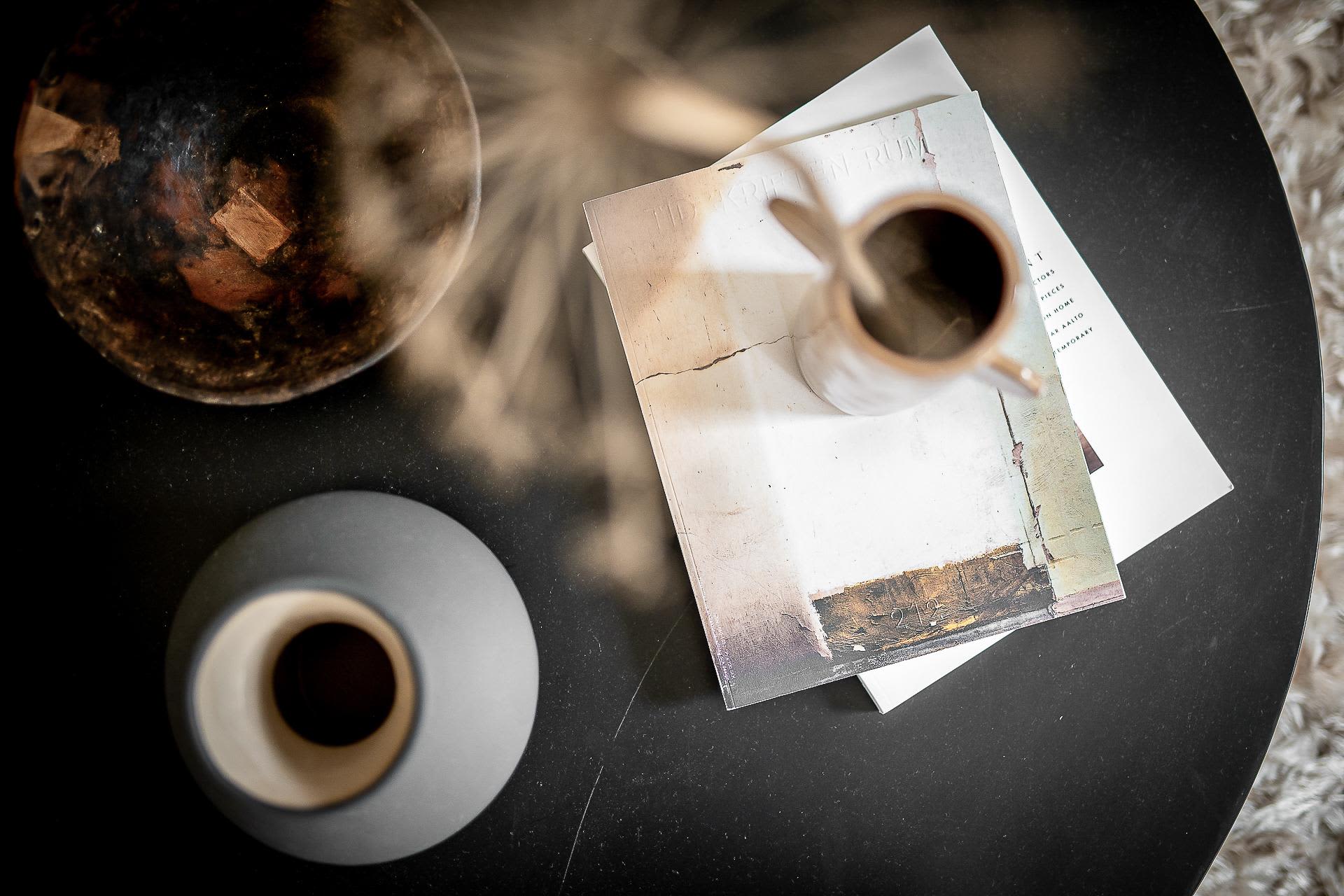 Ceramic vases and a pitcher on a coffee table in a modern living room setting.