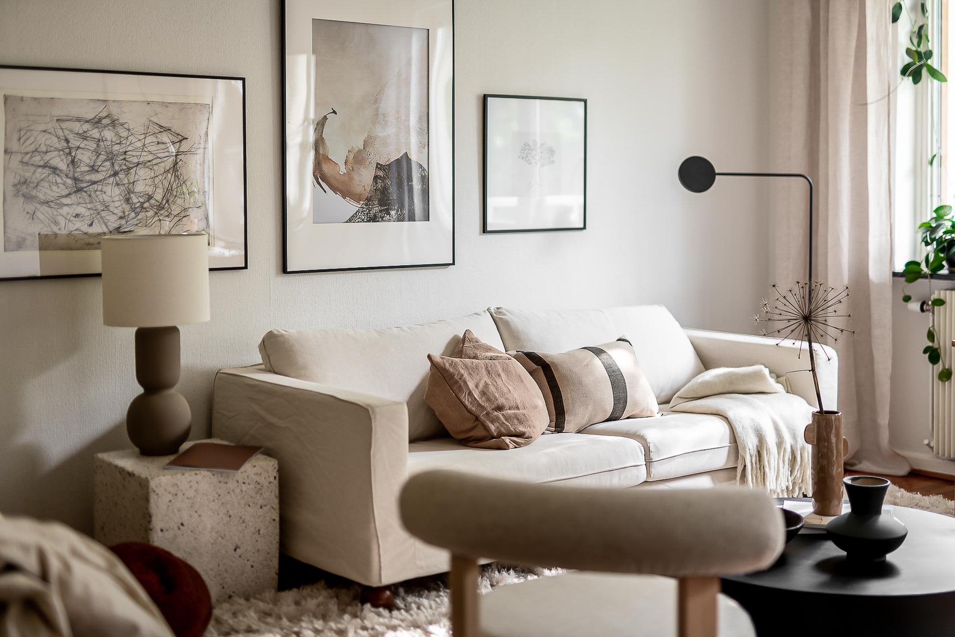 Modern living room featuring neutral tones with minimalist decor and comfortable seating.