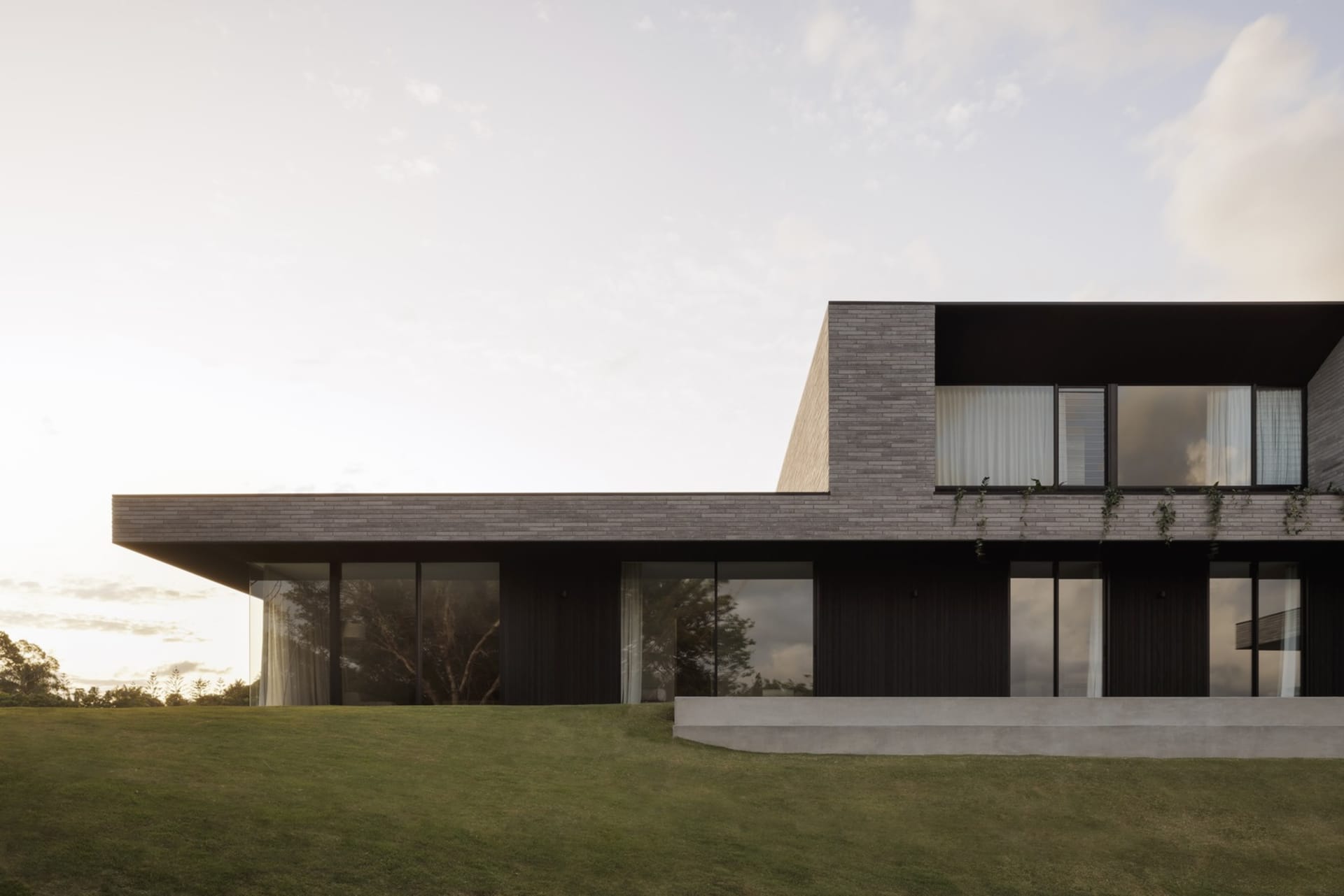 A modern house featuring concrete and glass exterior materials.