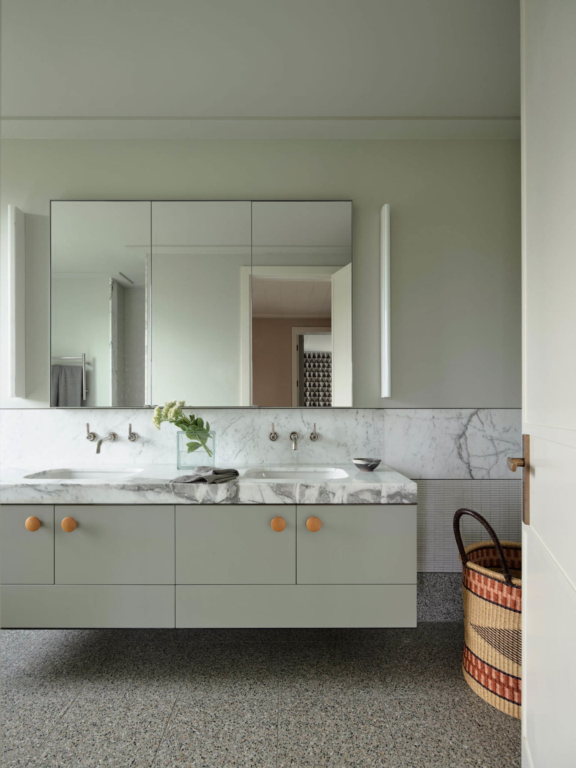 Modern bathroom with marble counter top and grey cabinets