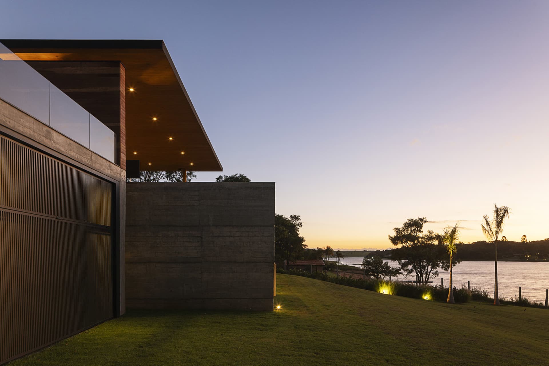 Modern home exterior featuring concrete and glass materials.